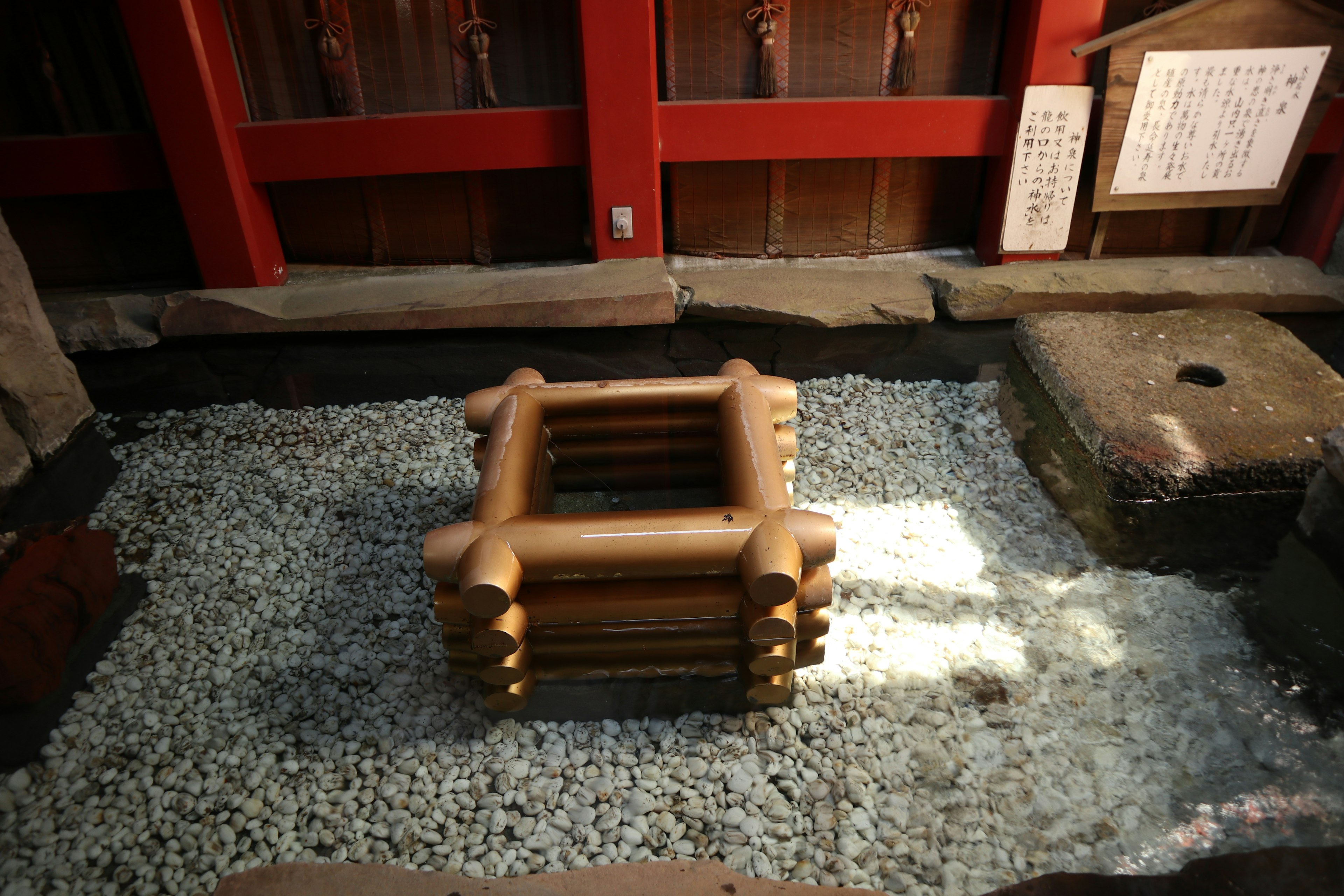 Wooden structure placed on stones inside a Japanese shrine