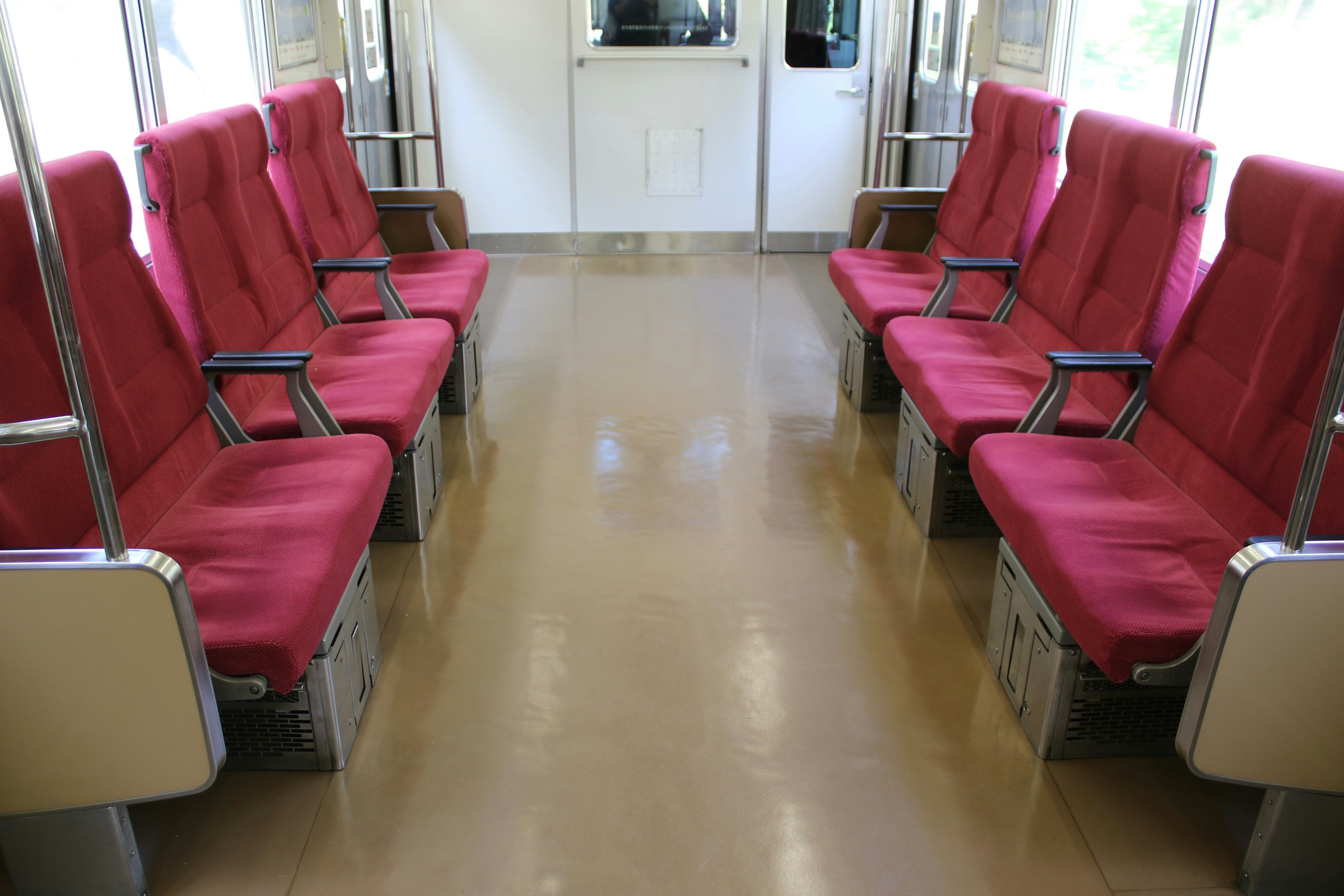 Interior of a train carriage with red seats