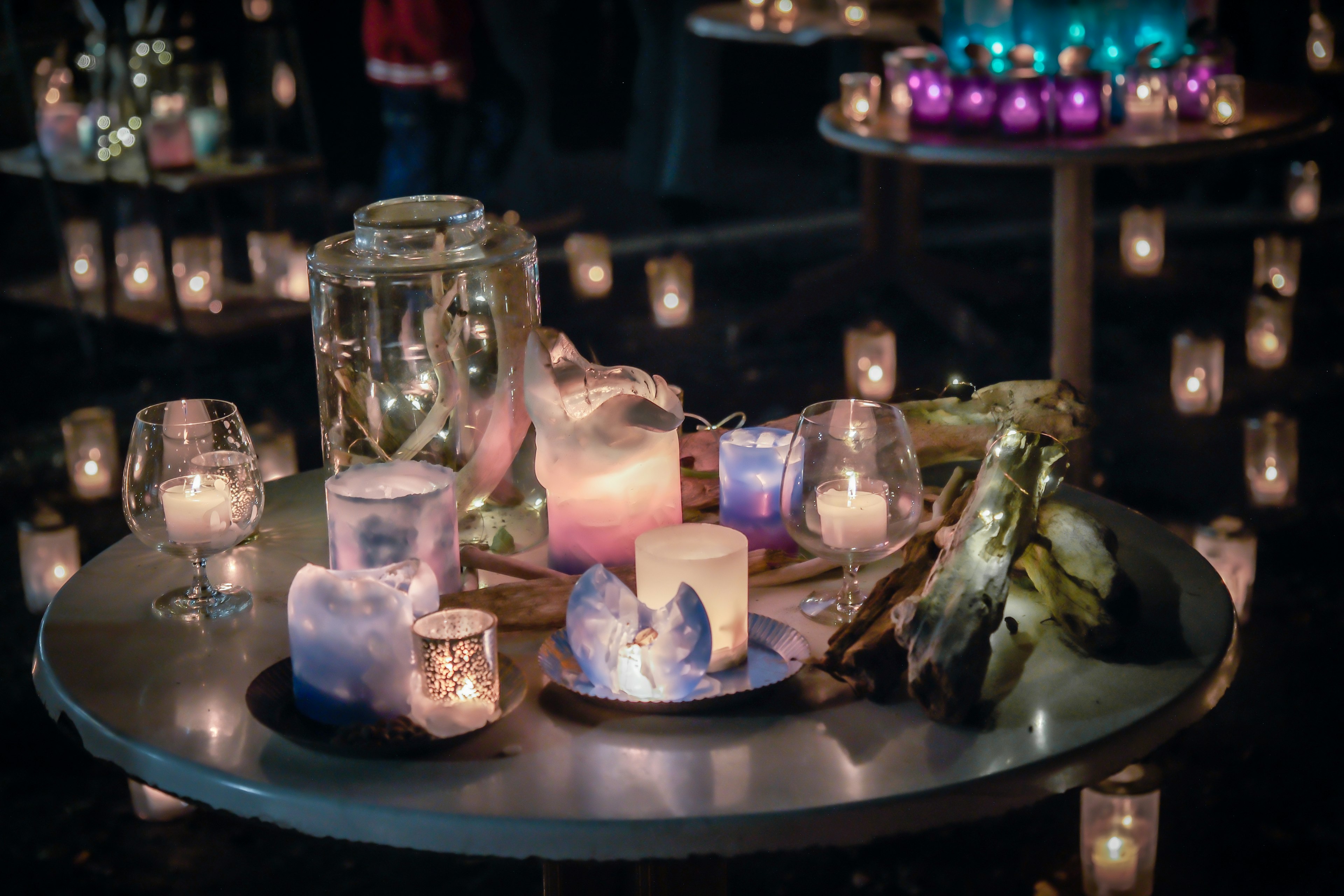 A table adorned with colorful candles and decorative elements creating a magical atmosphere