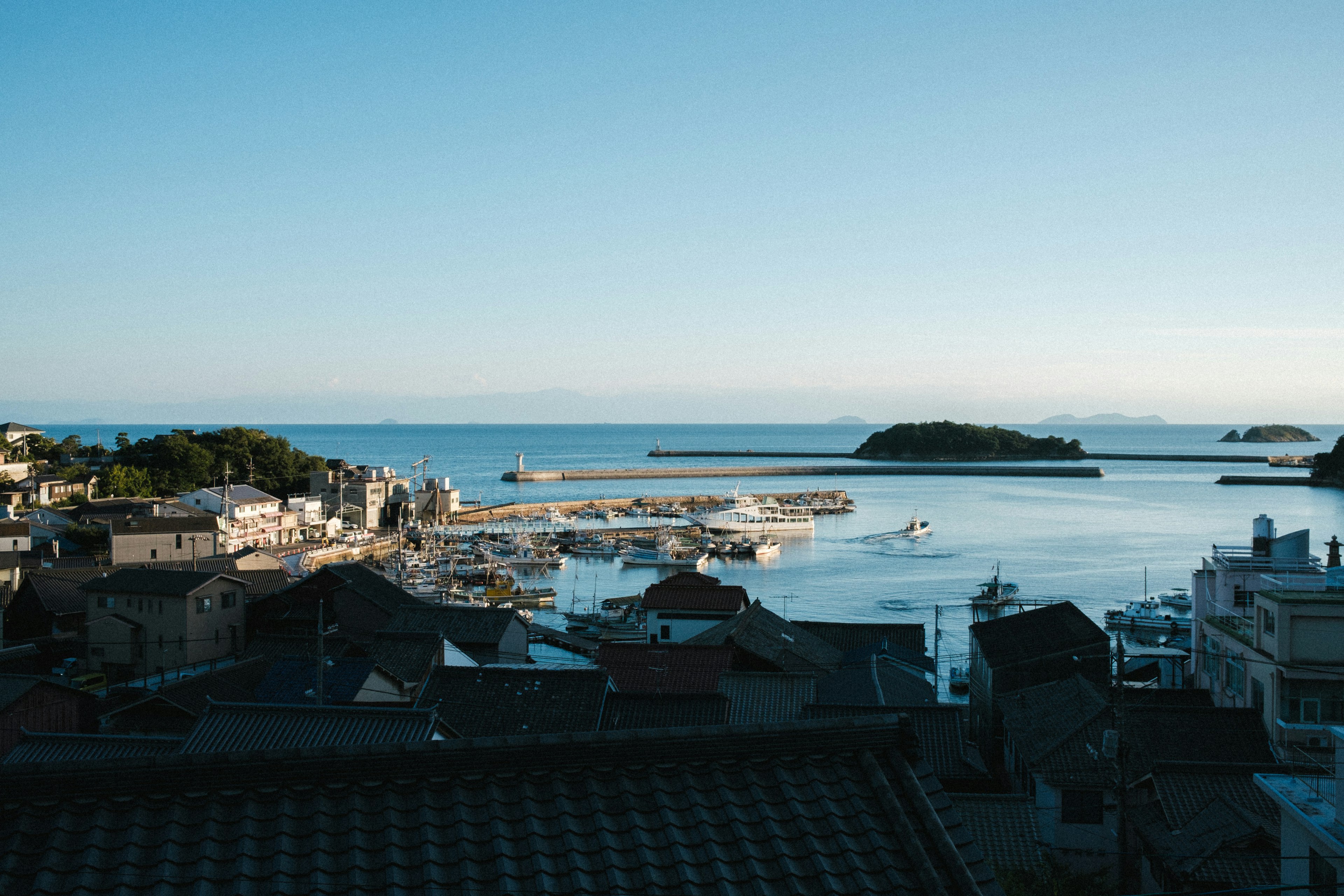 Scenic view of a coastal town with a harbor and tranquil sea