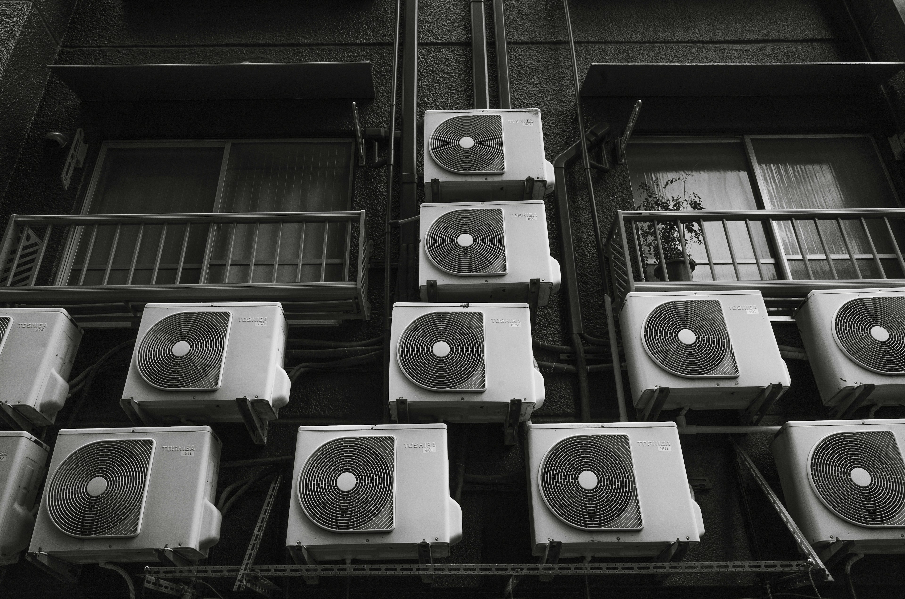 Numerous air conditioning units mounted on a building facade