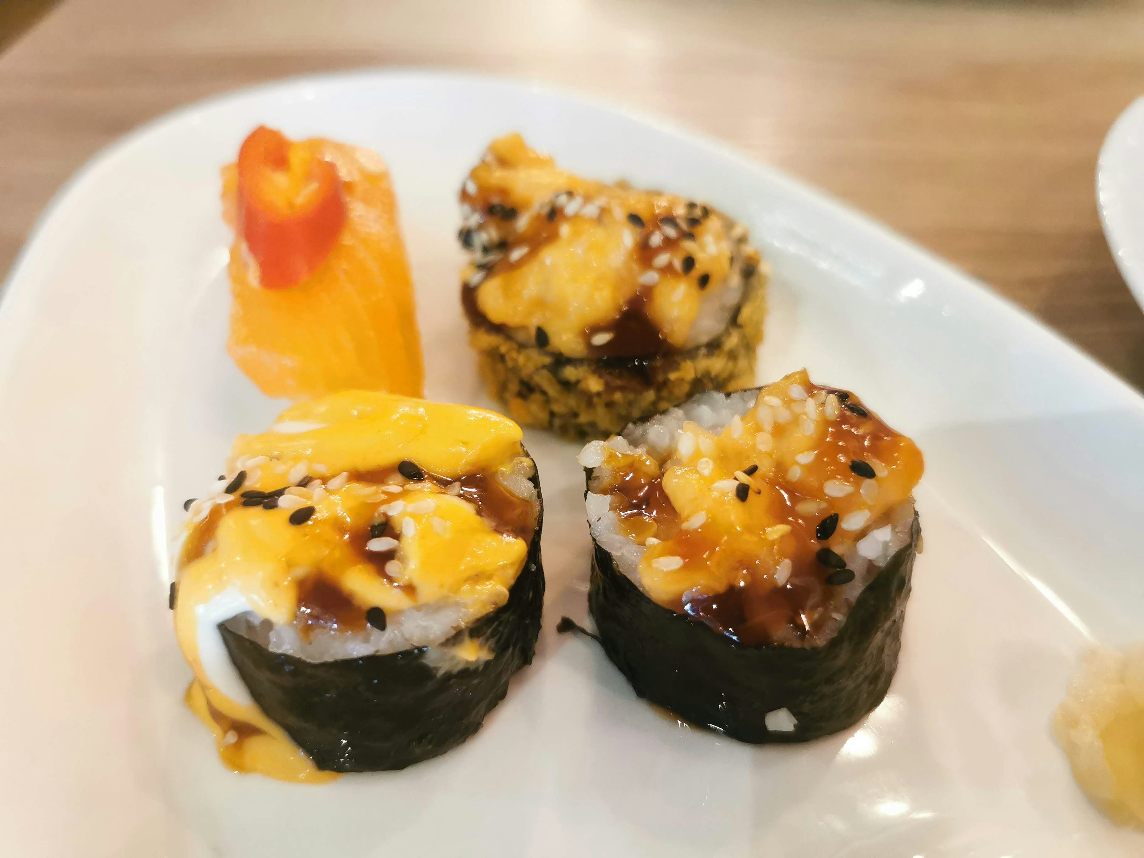 Delicious sushi platter featuring various topped sushi rolls