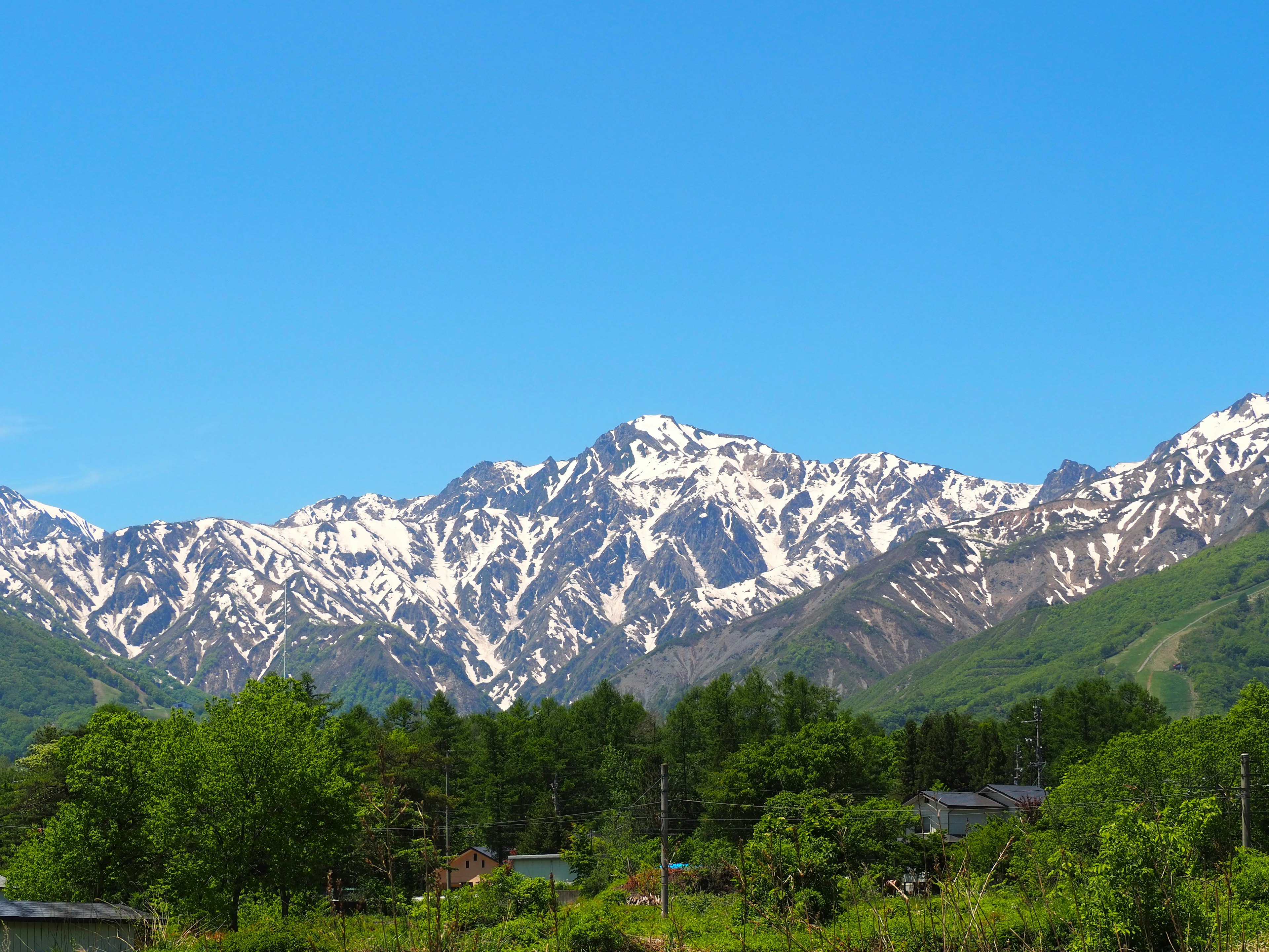 Scenic view of snow-capped mountains under a clear blue sky