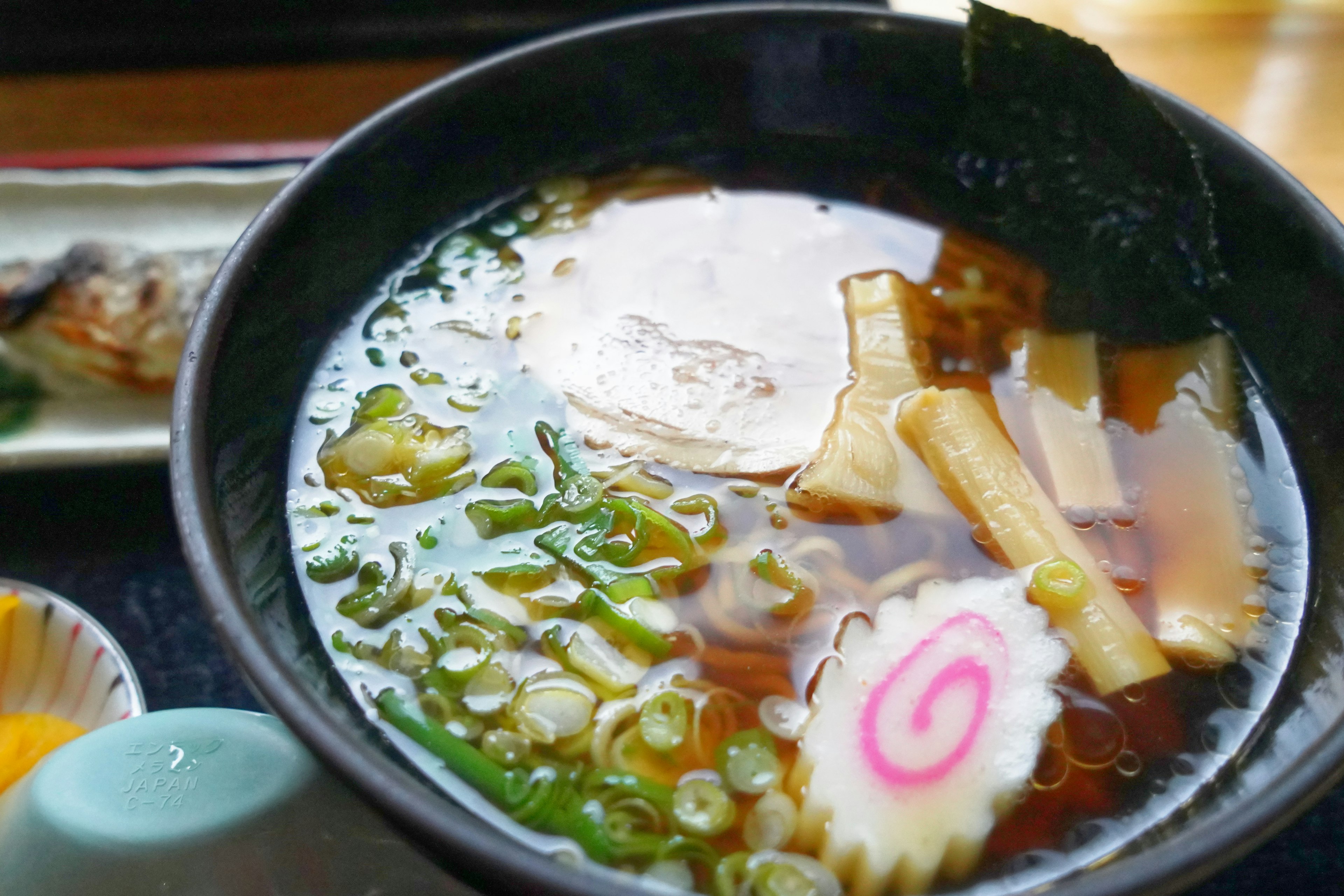 Bowl of ramen with broth and toppings visible