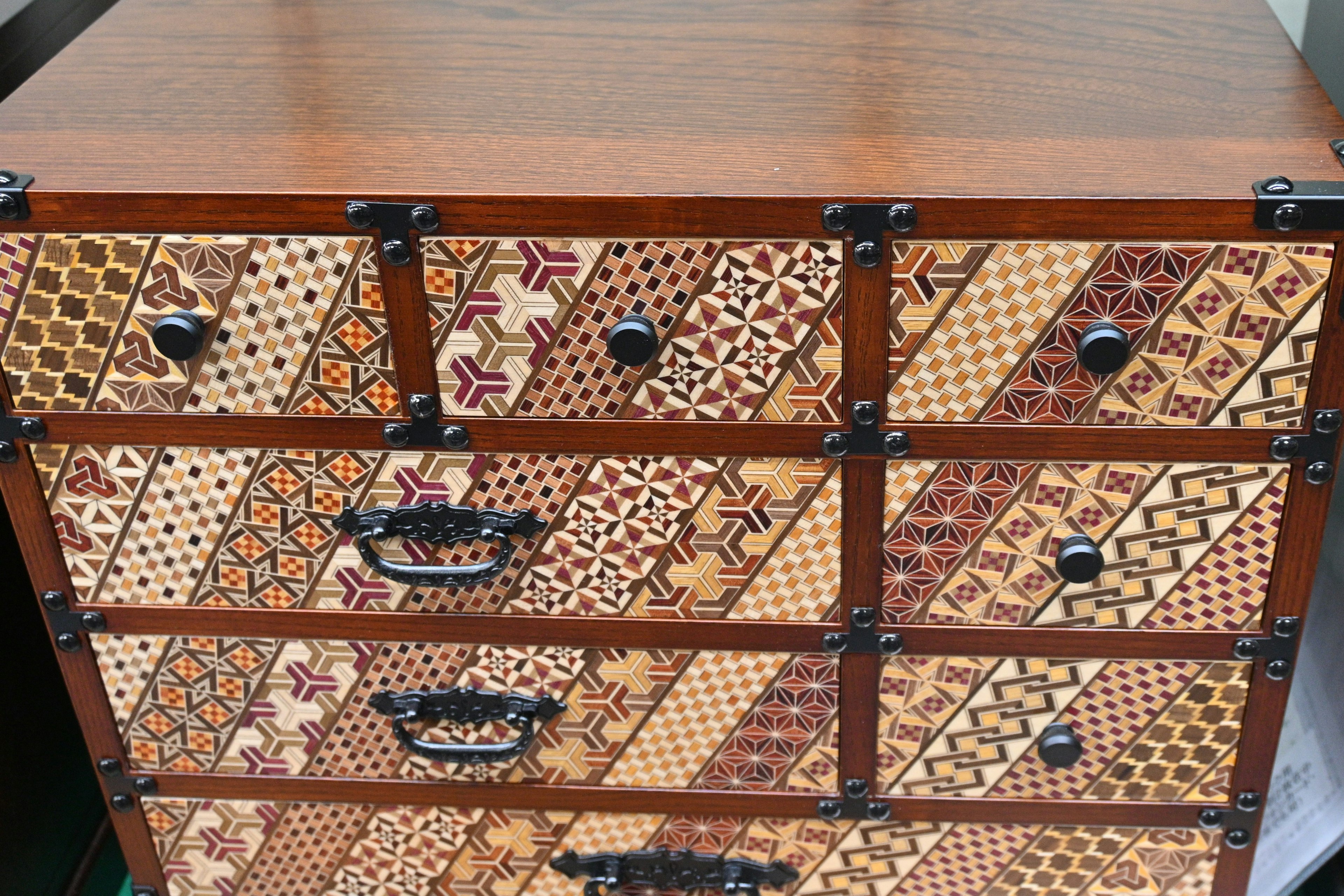 Decorative wooden chest of drawers with intricate patterns