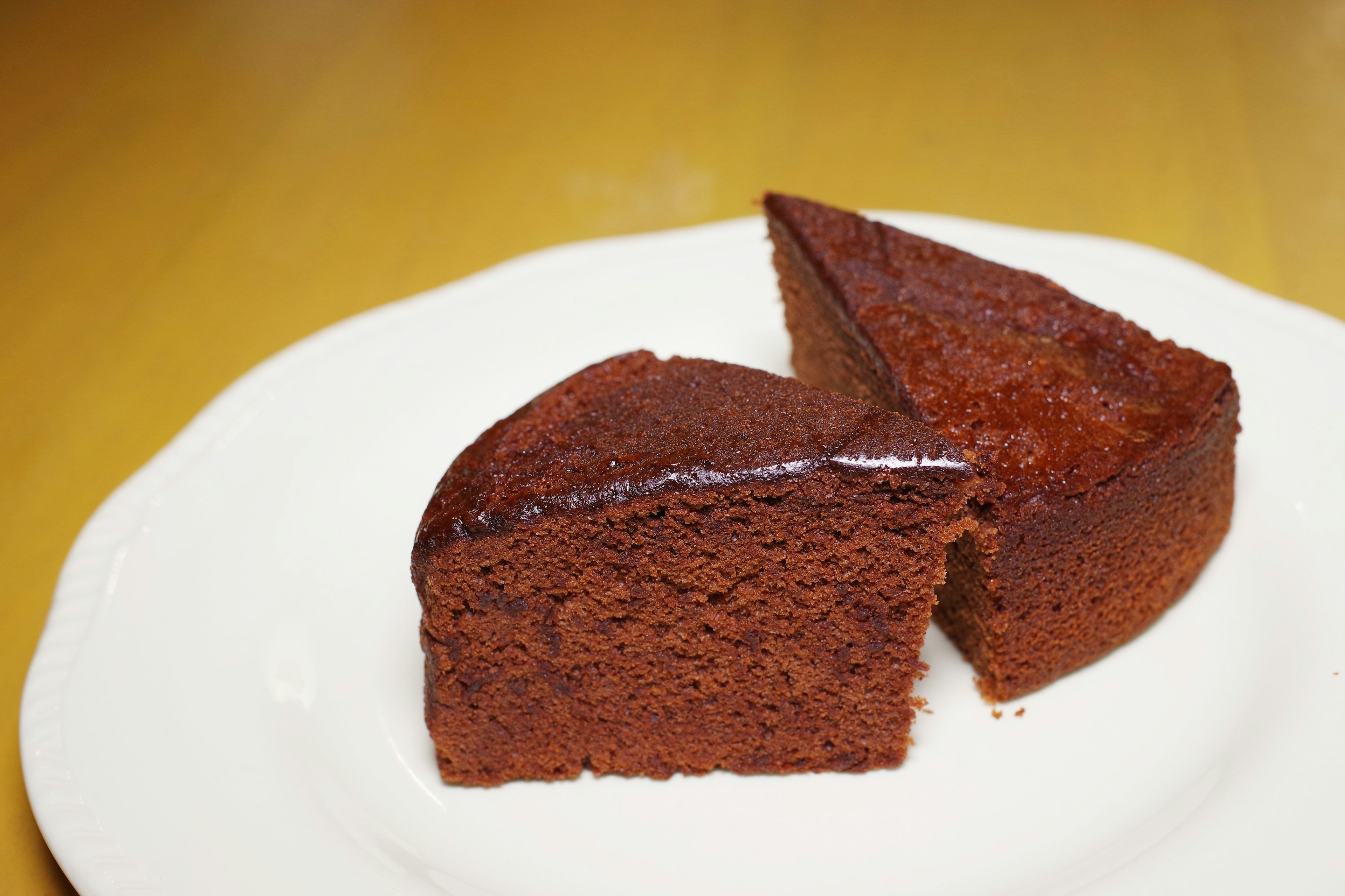 Slice of chocolate cake on a white plate