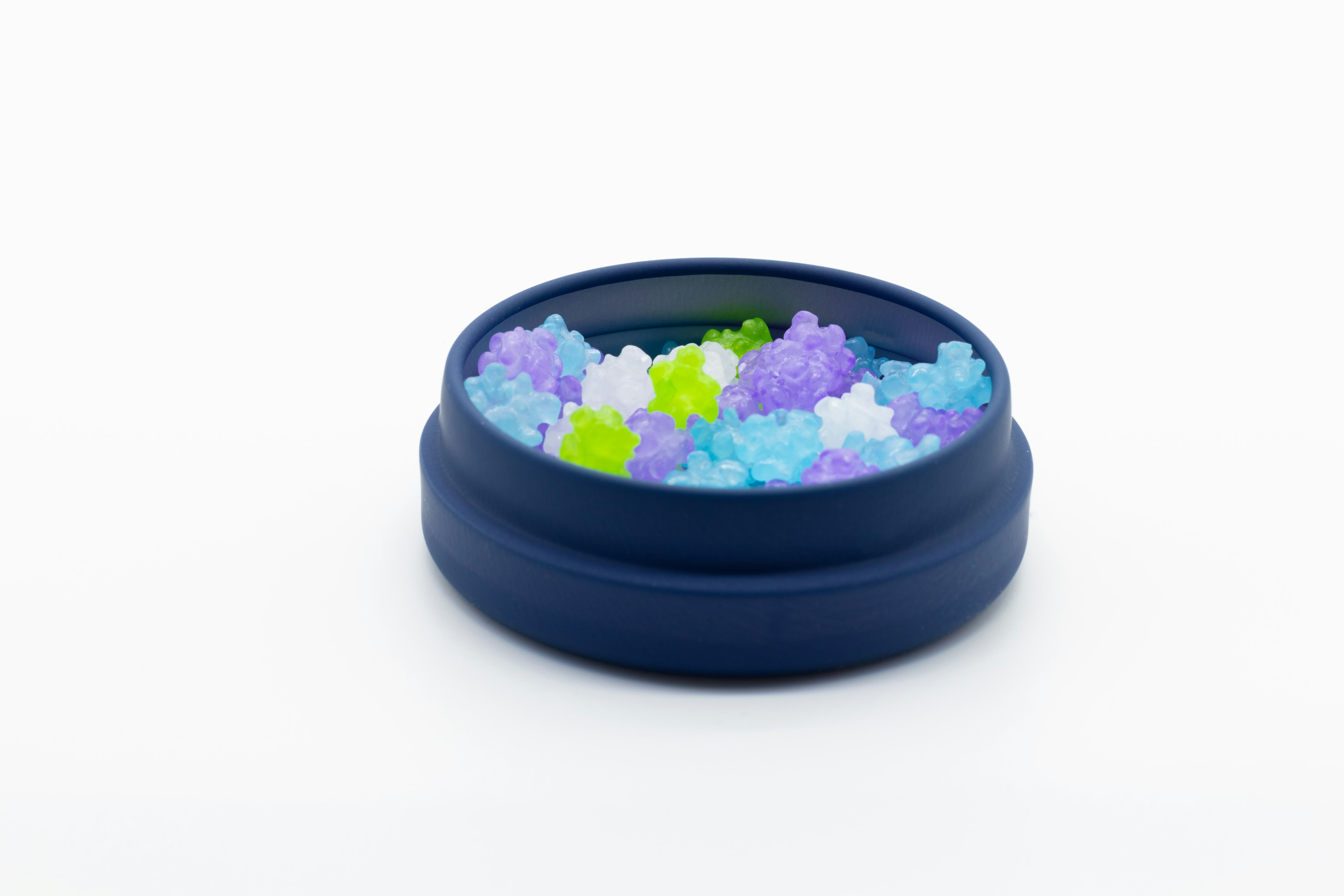 A blue container filled with colorful jelly-like beads