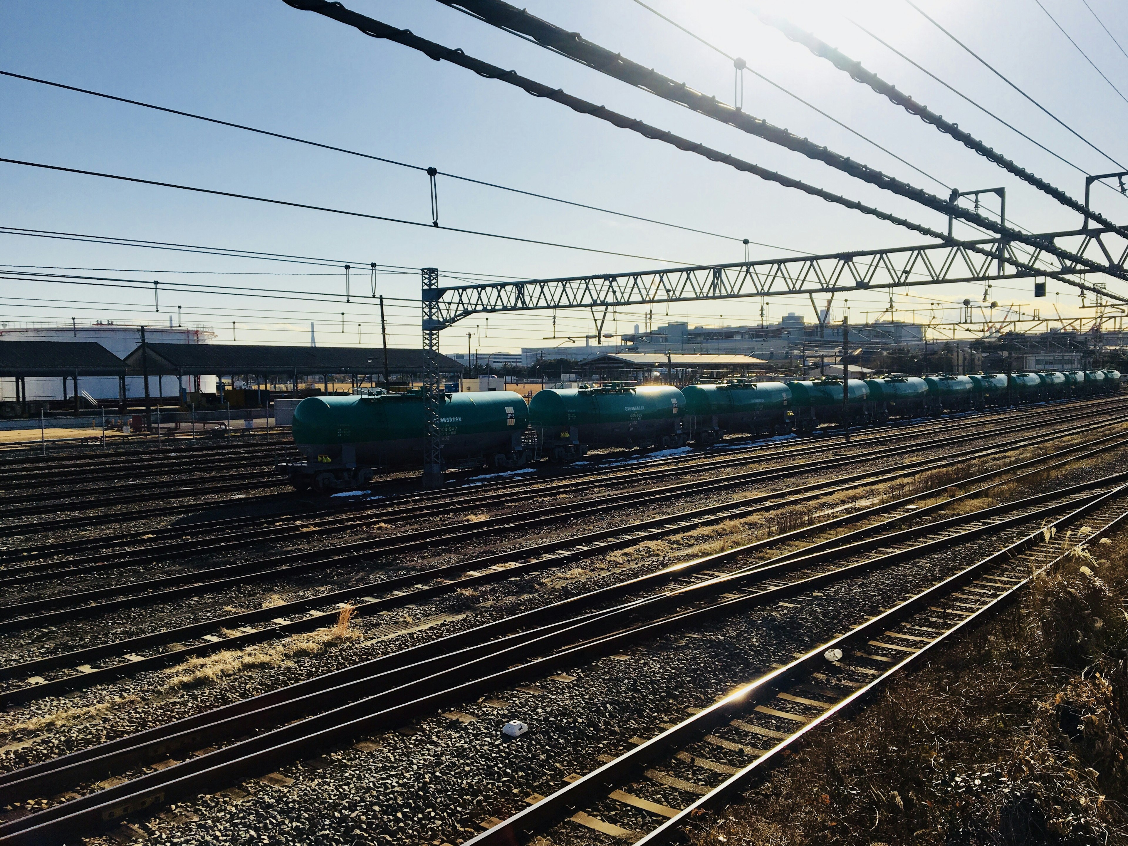 A view of a freight train with blue cars lined up along the railway tracks