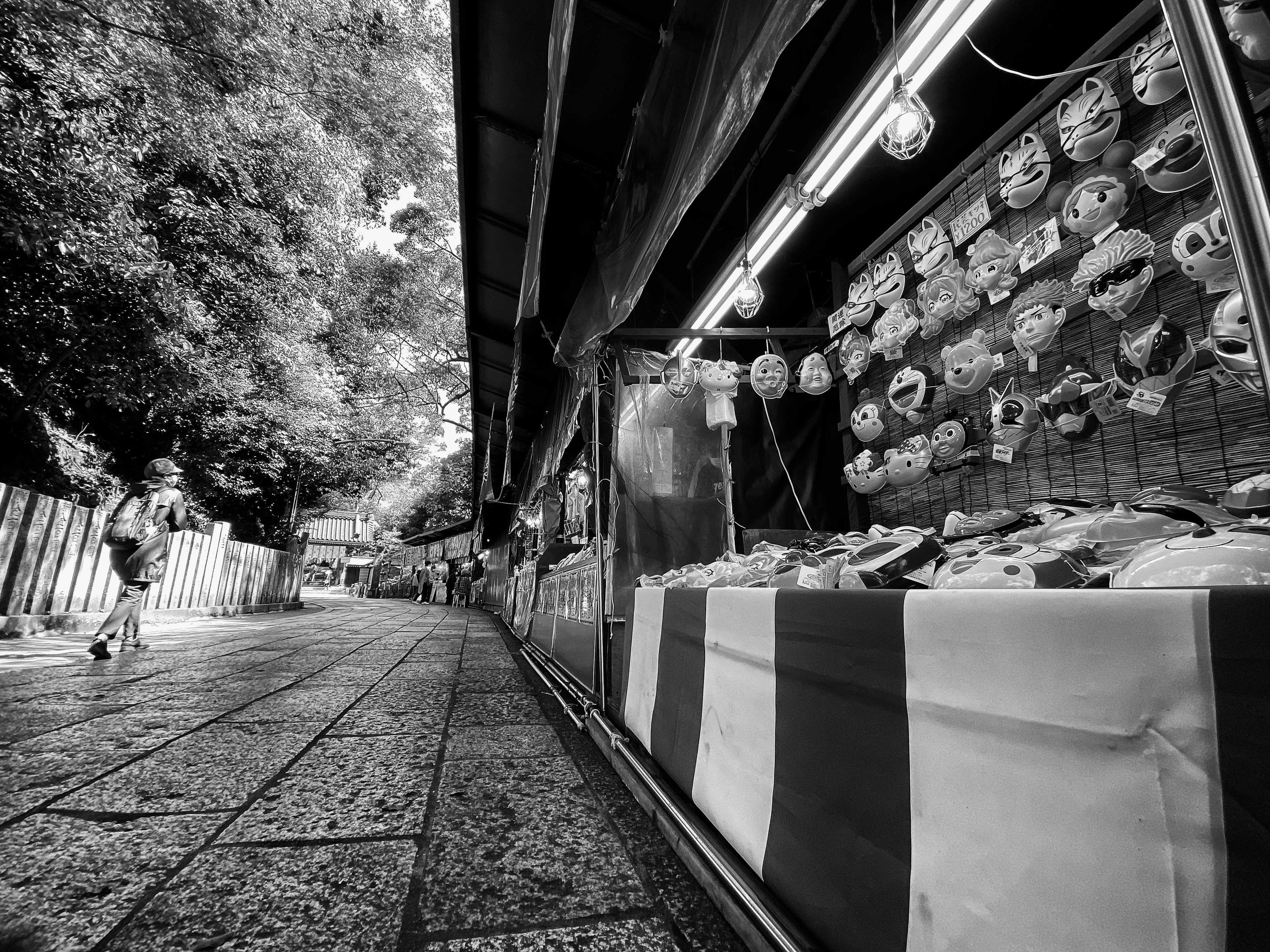 Black and white photo of a market stall with colorful decorations