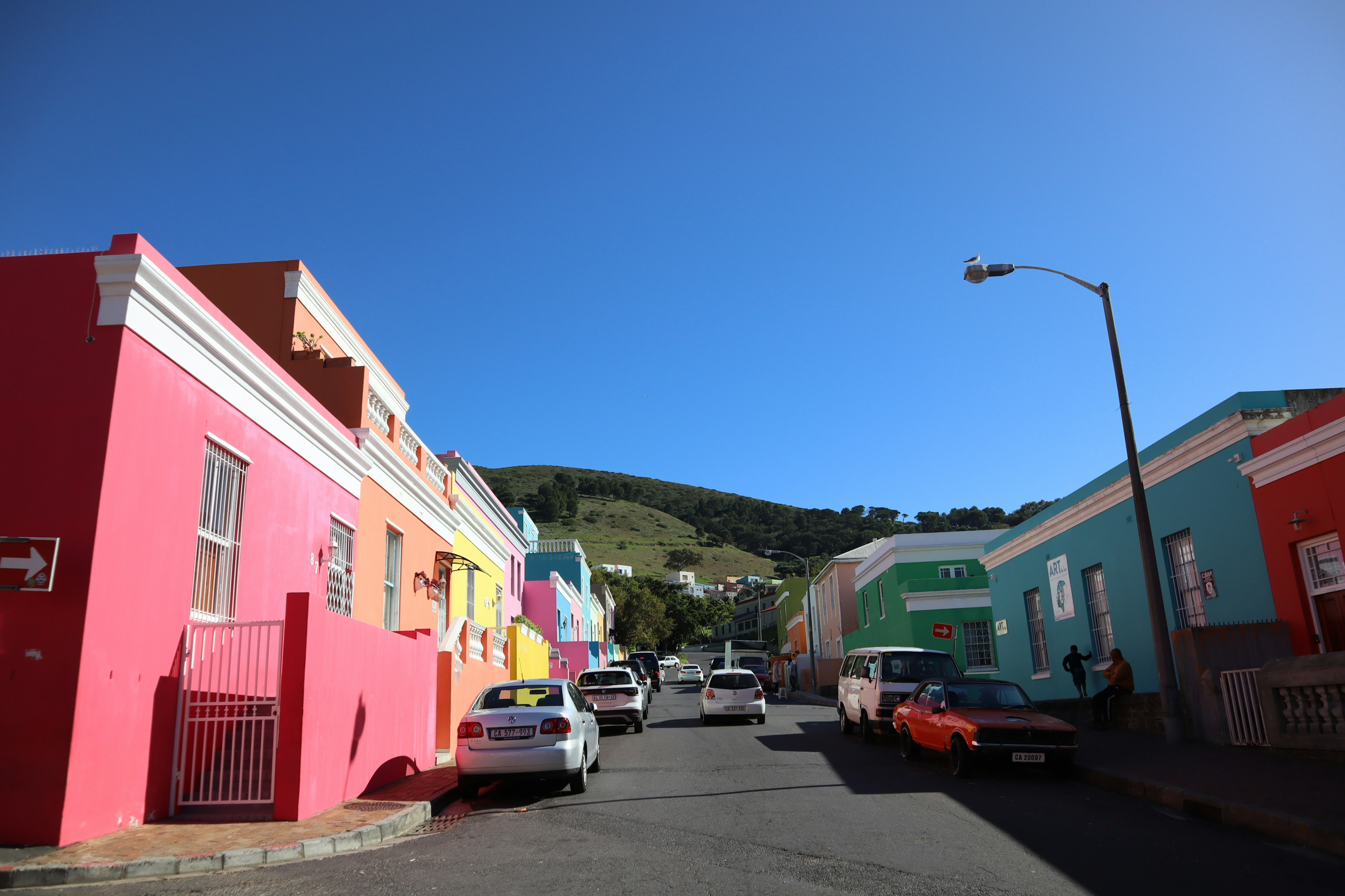 Colorful houses lining the street under a clear blue sky