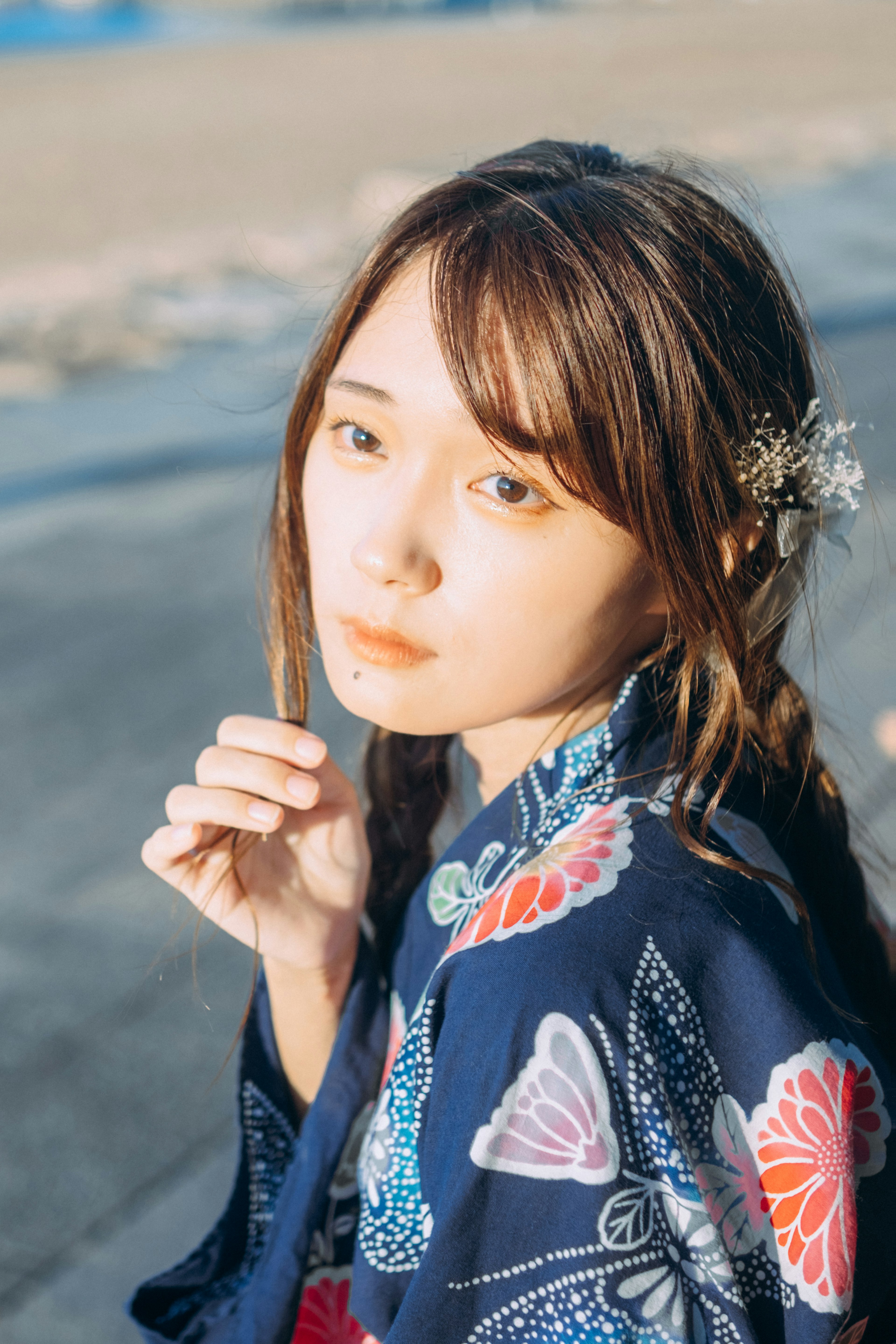 Eine Frau in einem kimono mit floralen Mustern am Meer