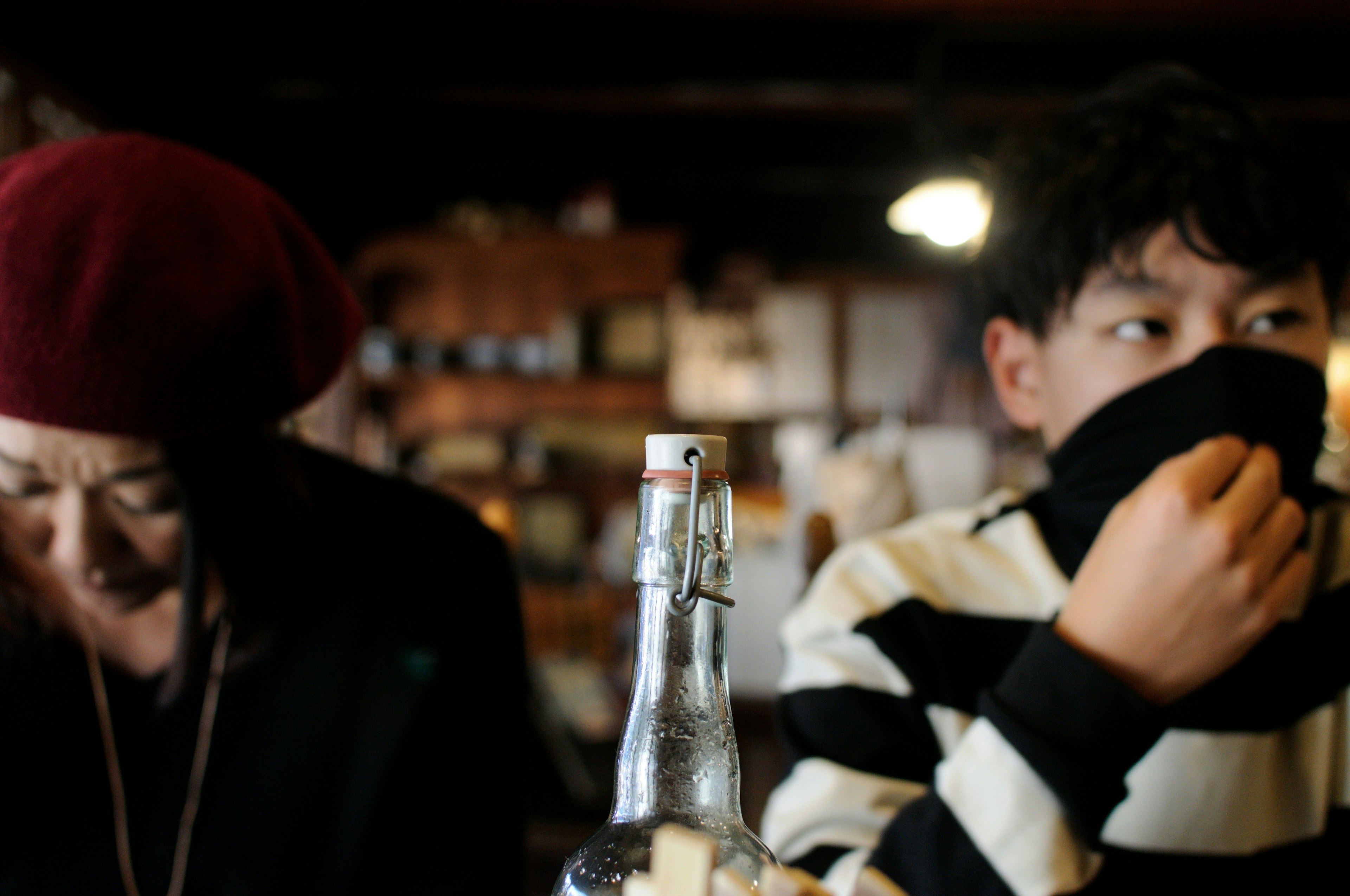 Image capturing an intimate moment between a young man and an elderly woman in a cafe