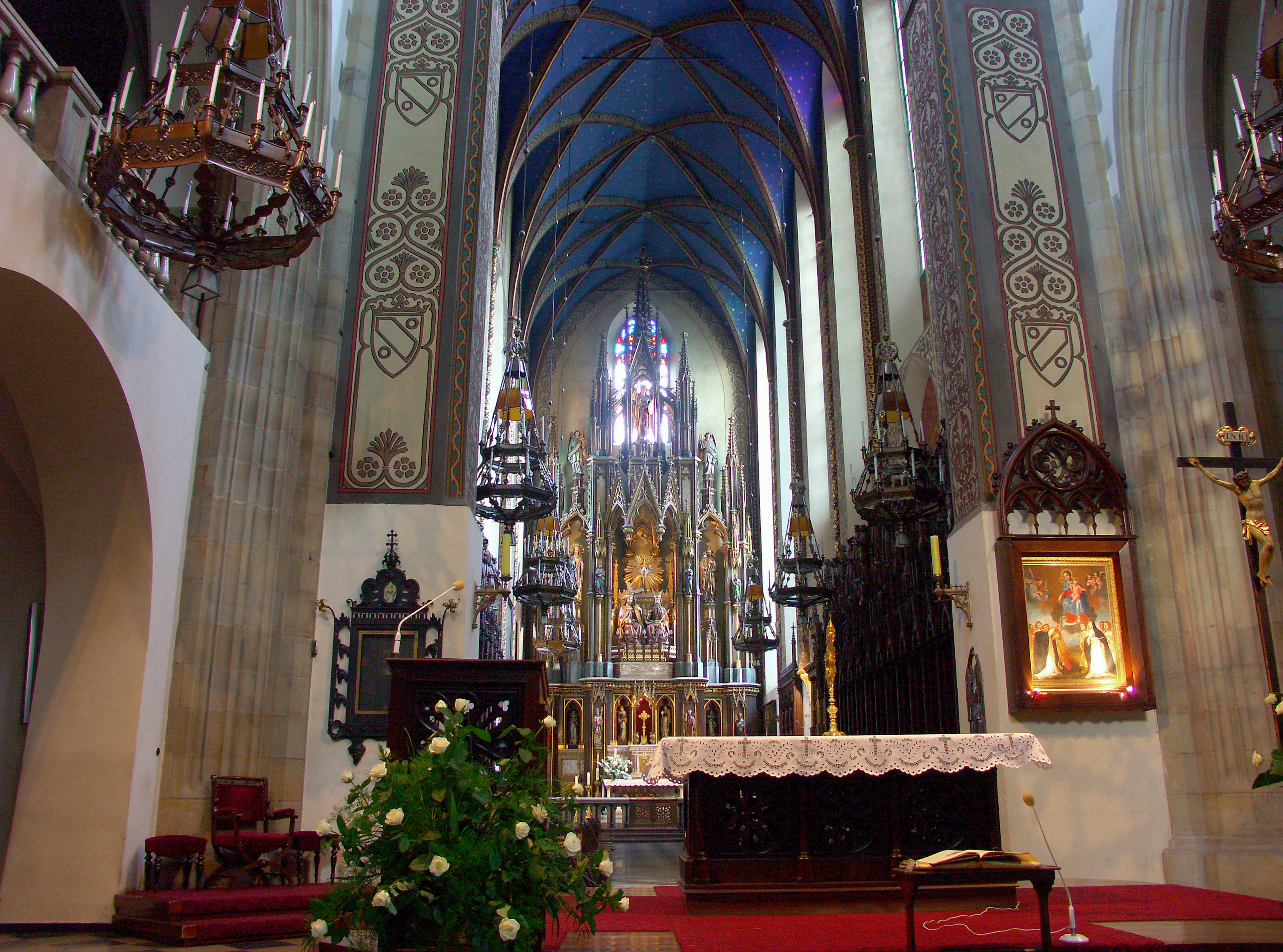 Interior of a church with a grand altar and beautiful vaulted ceiling