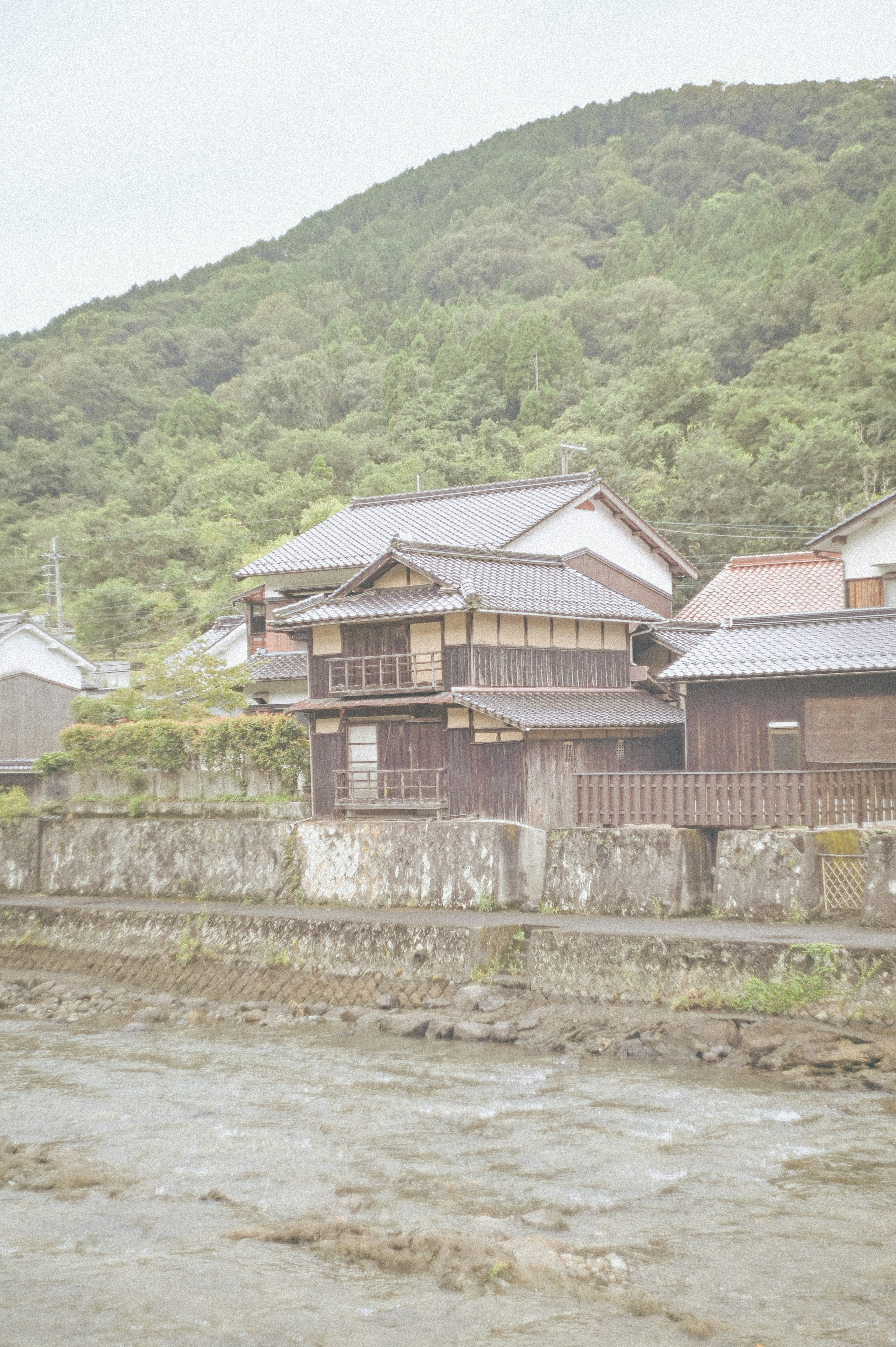 Traditional Japanese house at the foot of a mountain surrounded by nature