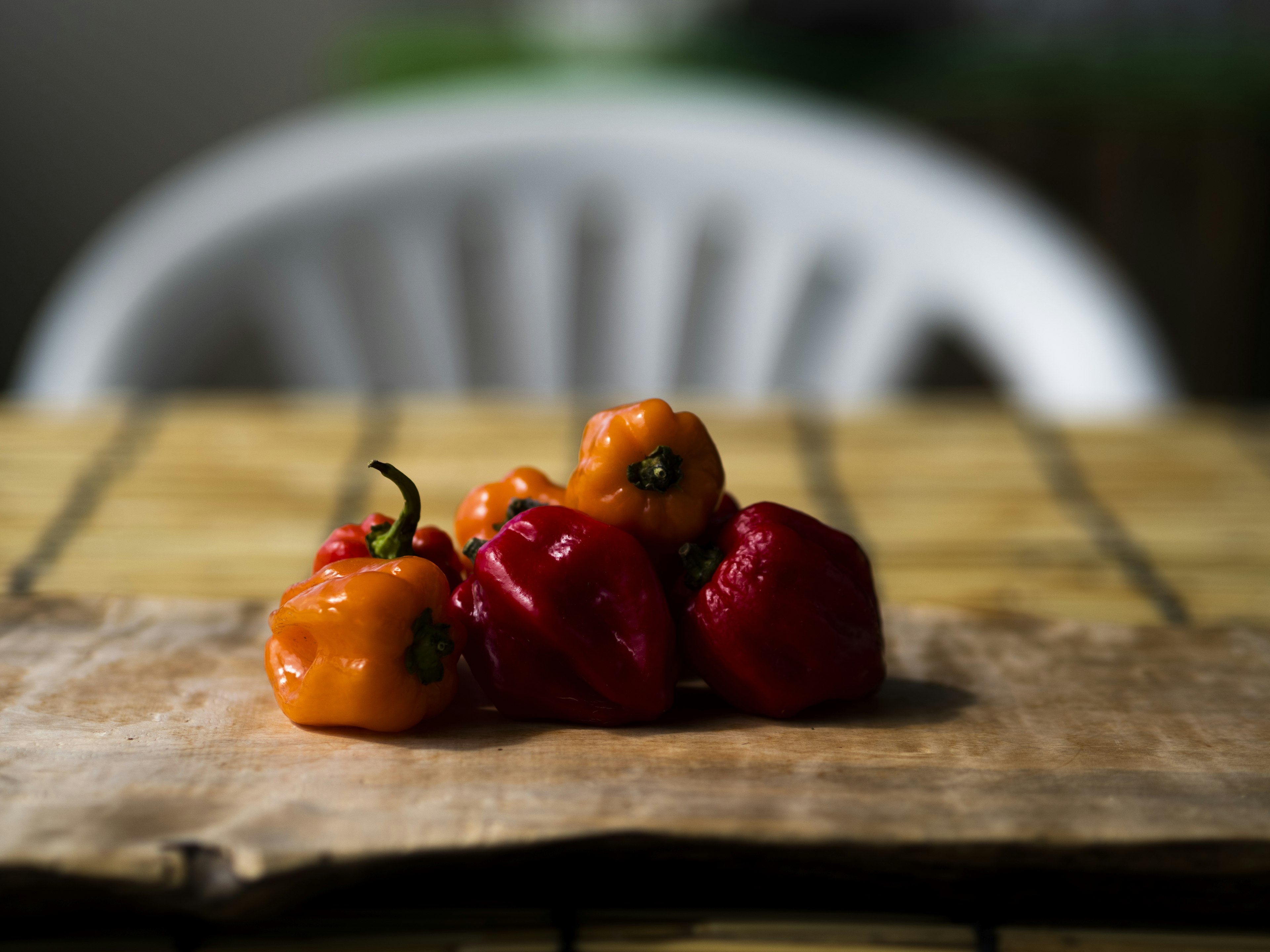 A cluster of colorful peppers on a wooden table