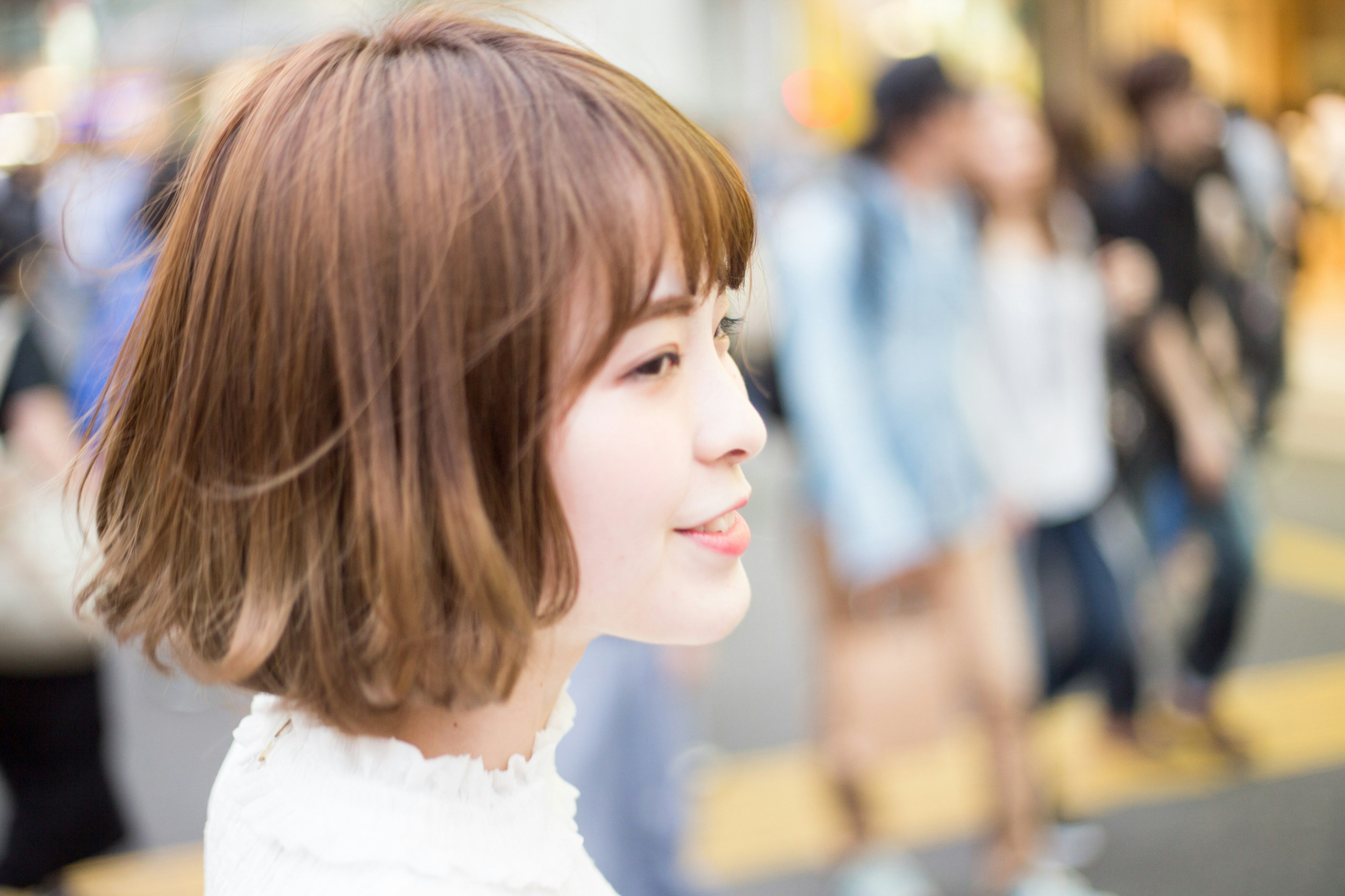 A beautiful woman captured in profile while walking in the city