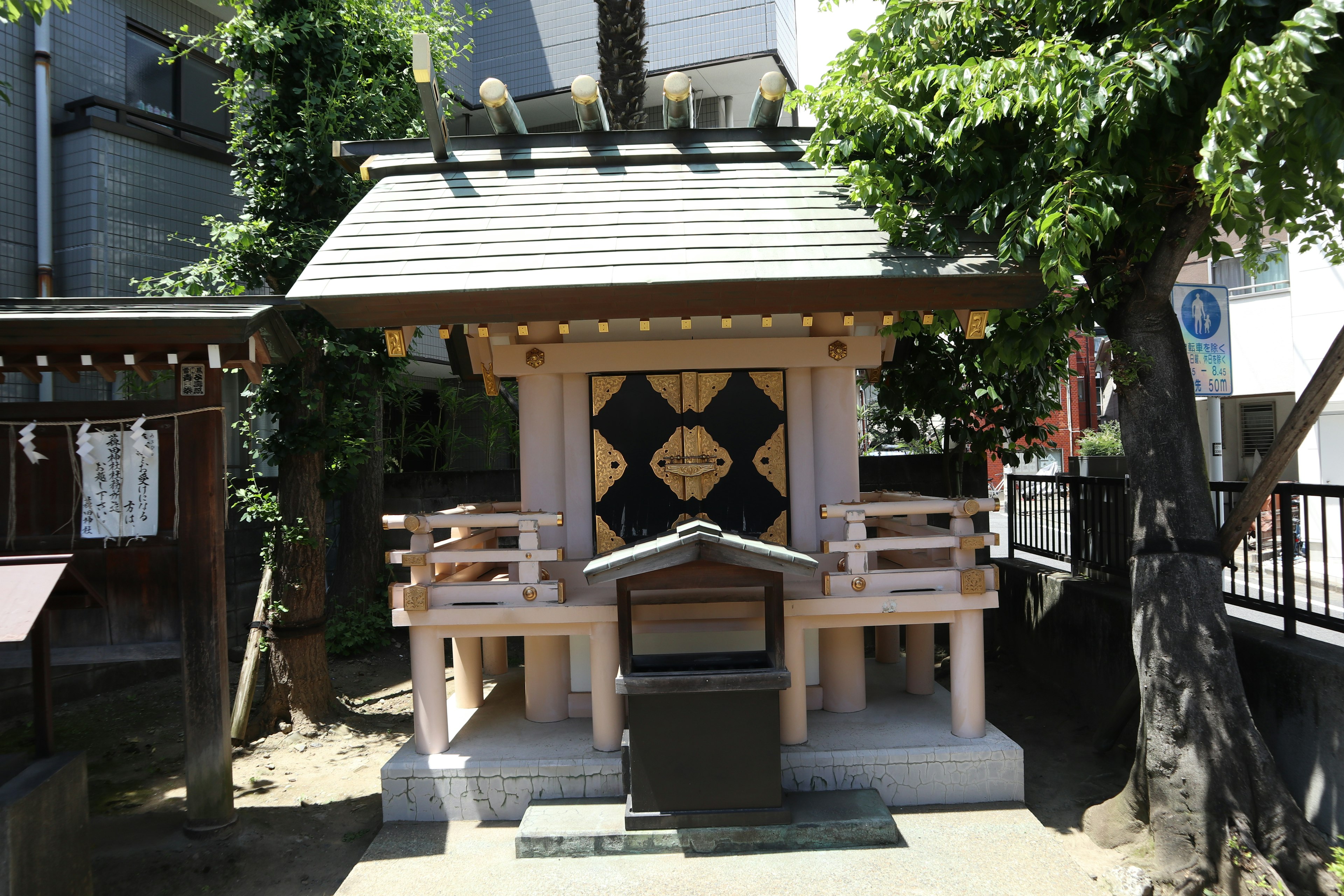 A small shrine building surrounded by greenery