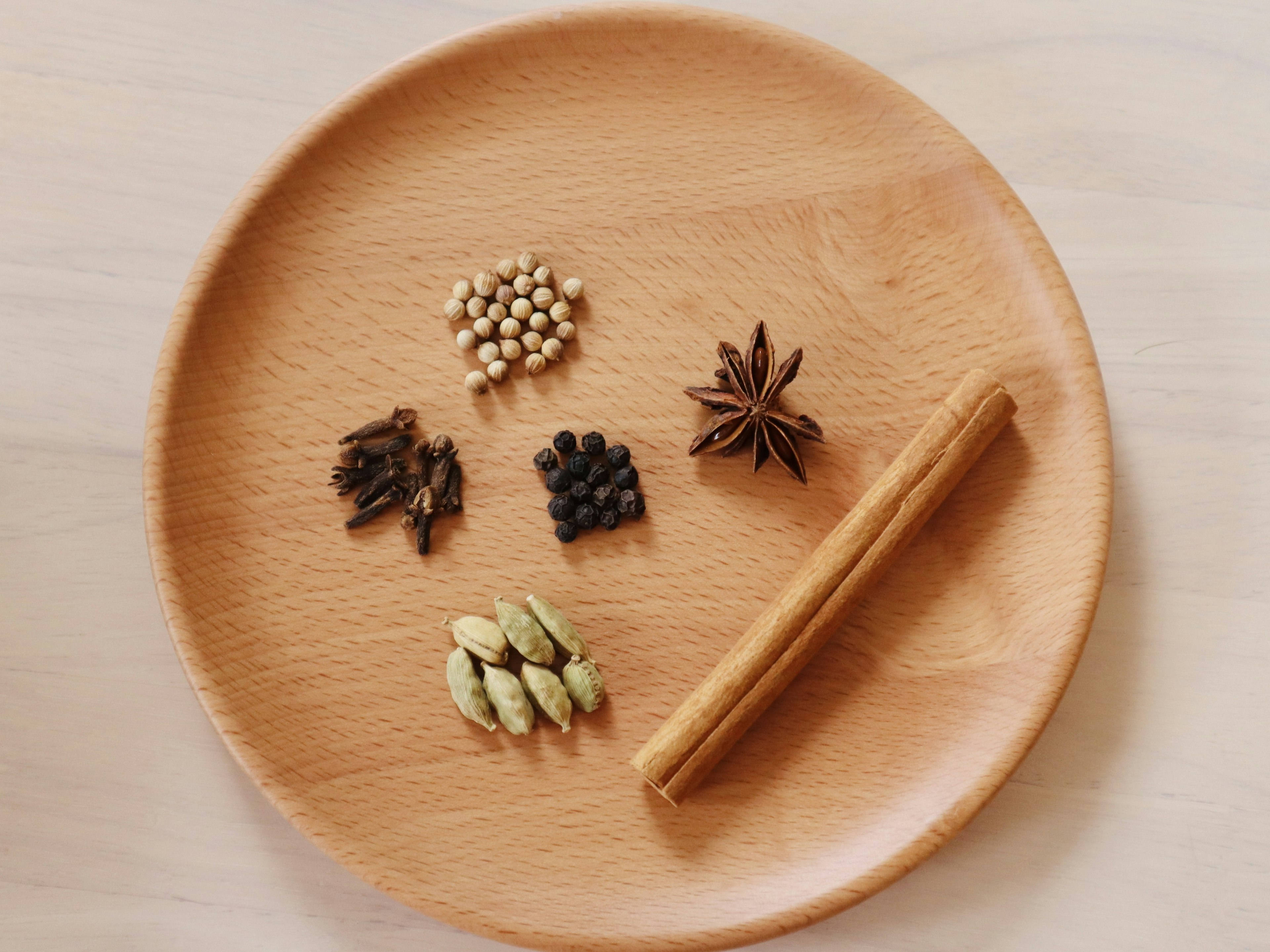 Spices arranged on a wooden plate