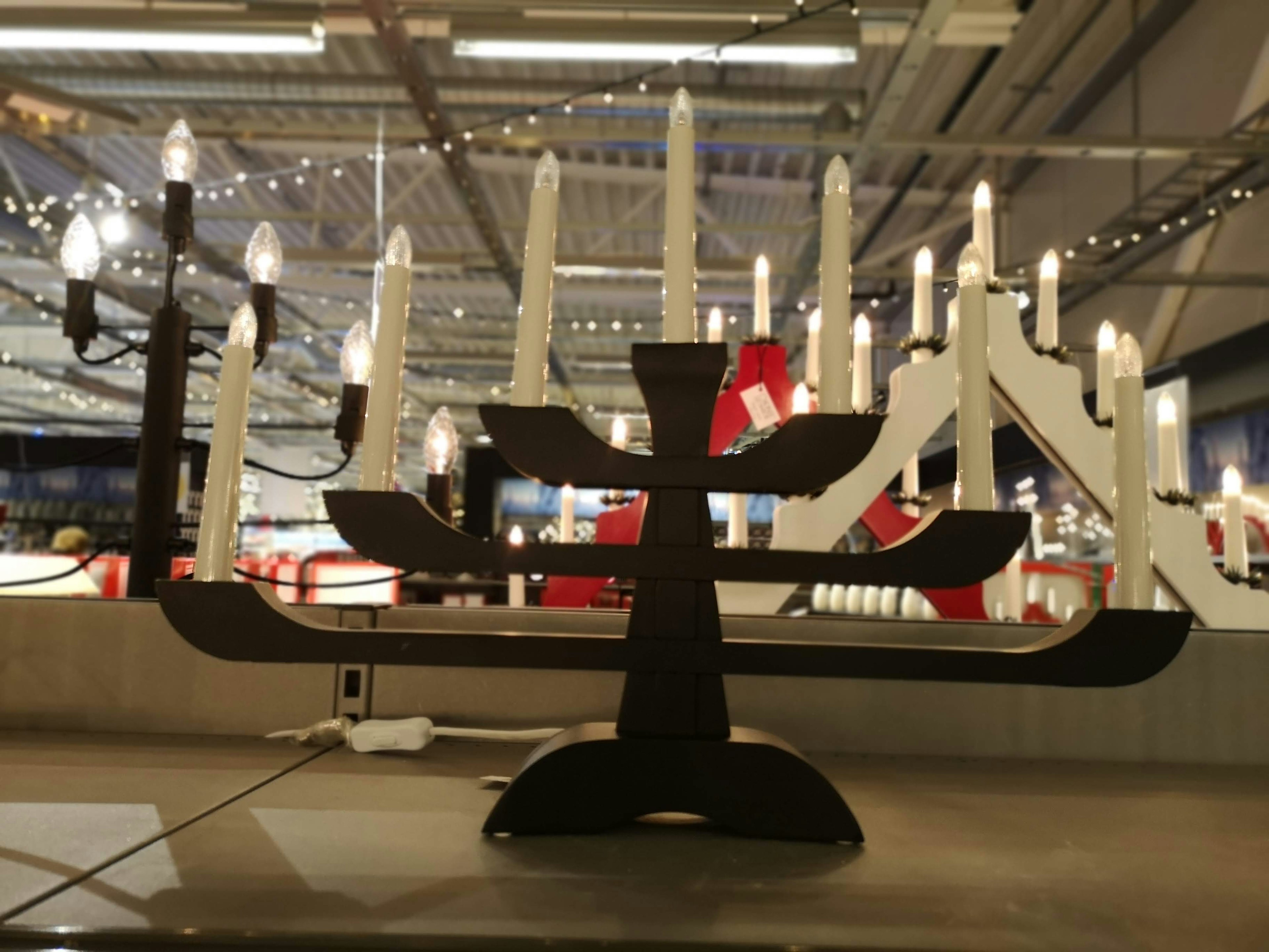 Modern black and white menorah displayed in a shopping area