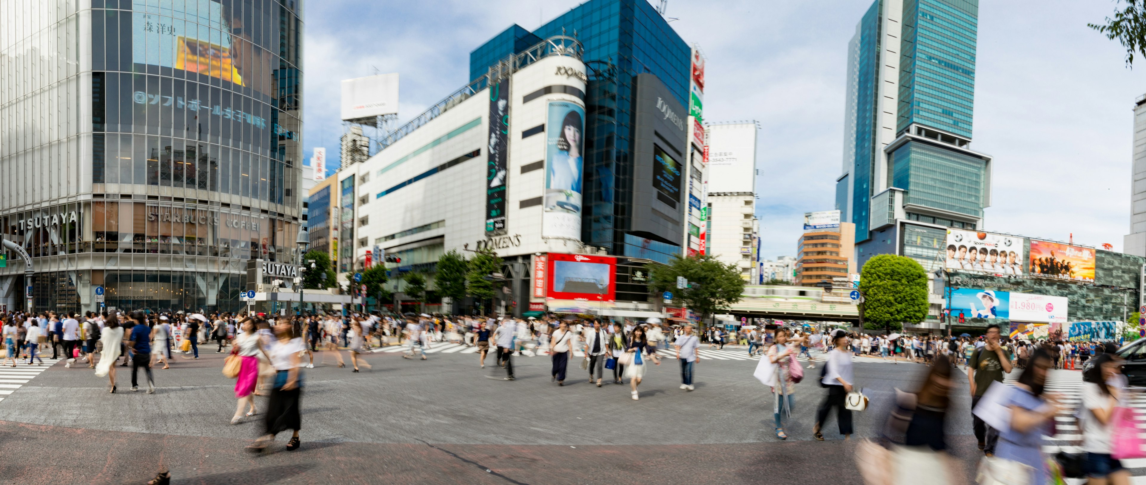 Busy Shibuya Crossing with pedestrians and skyscrapers