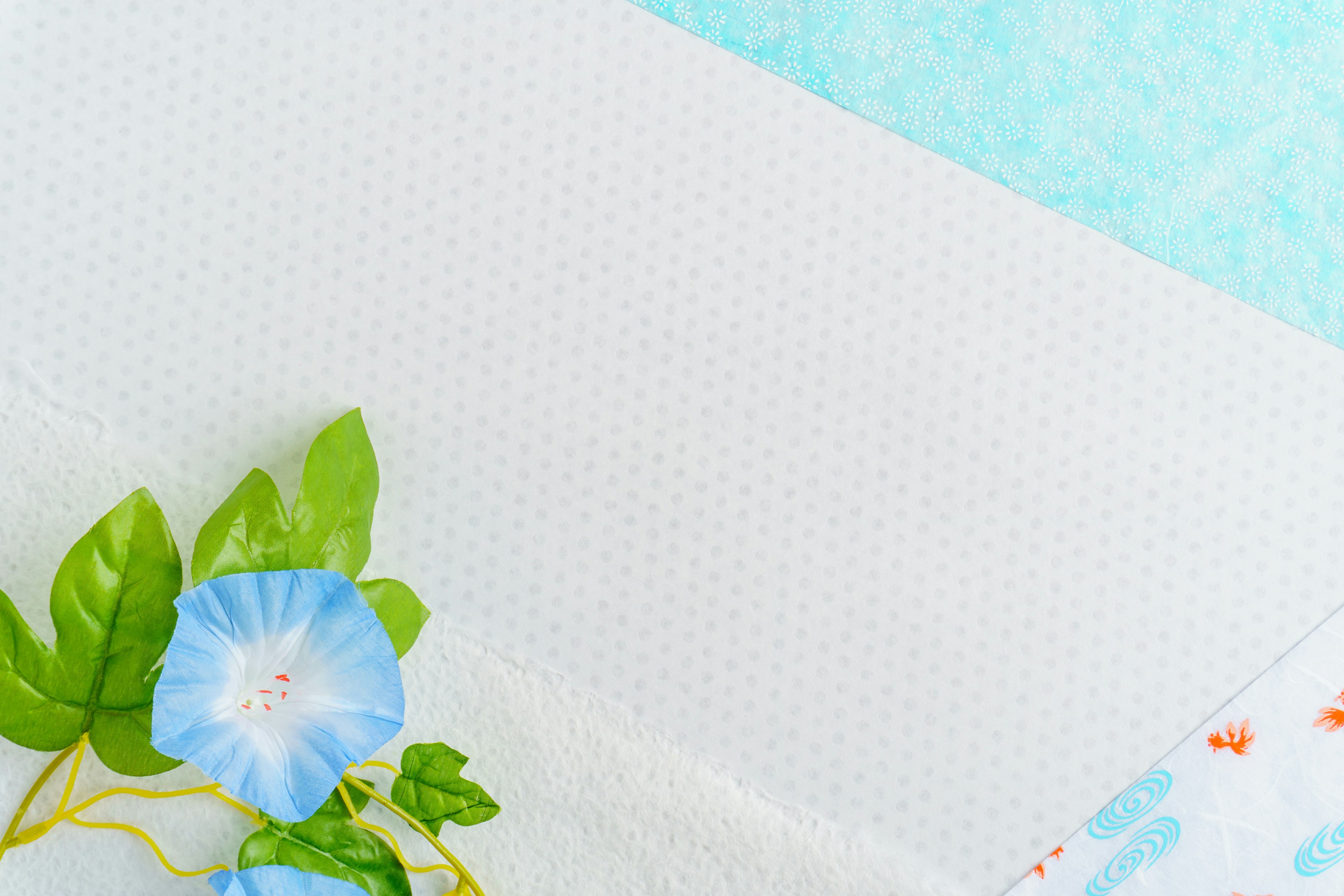 White fabric with blue morning glory flower and green leaves