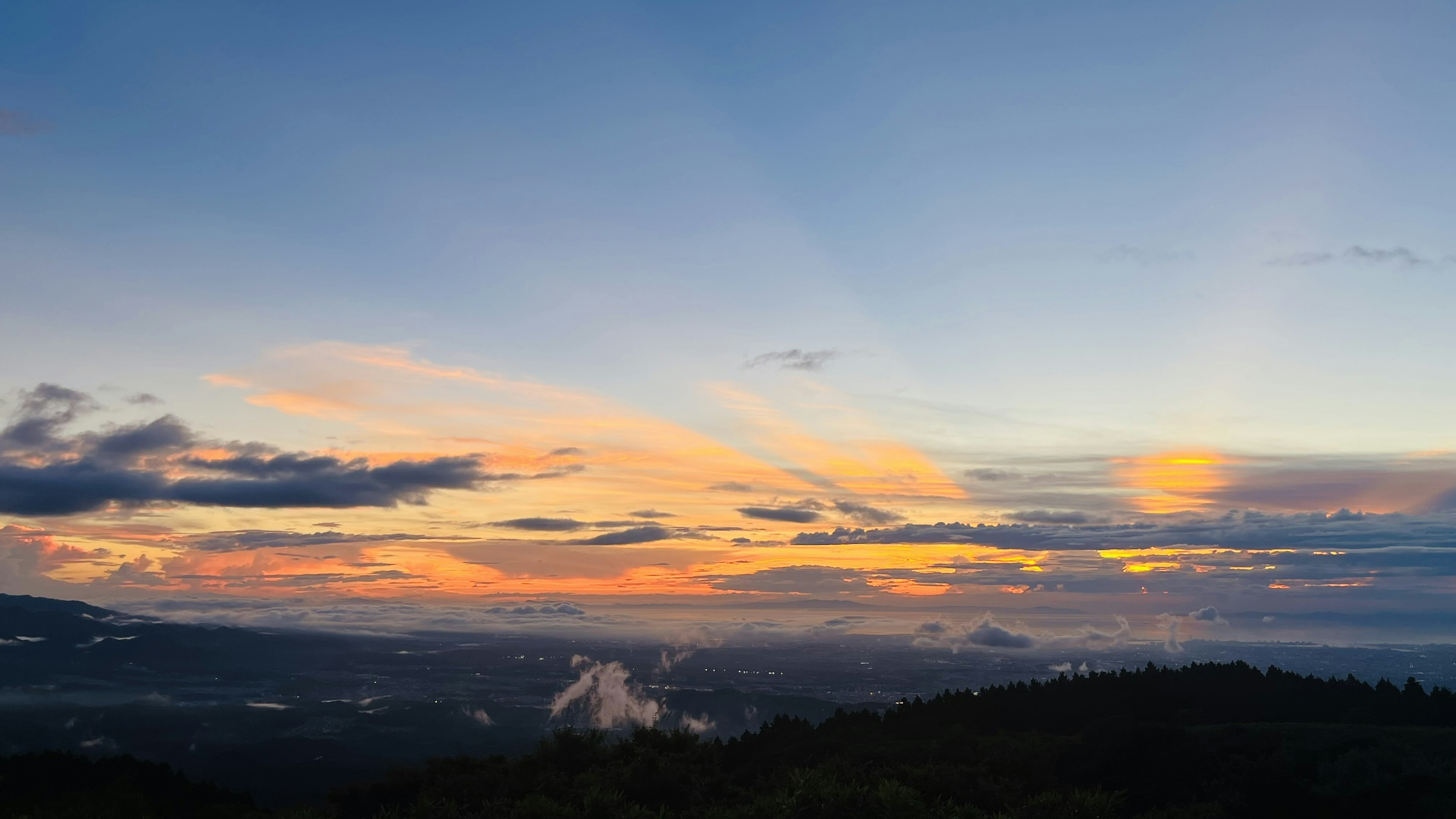 Stunning sunset over mountains with colorful clouds and soft light gradients