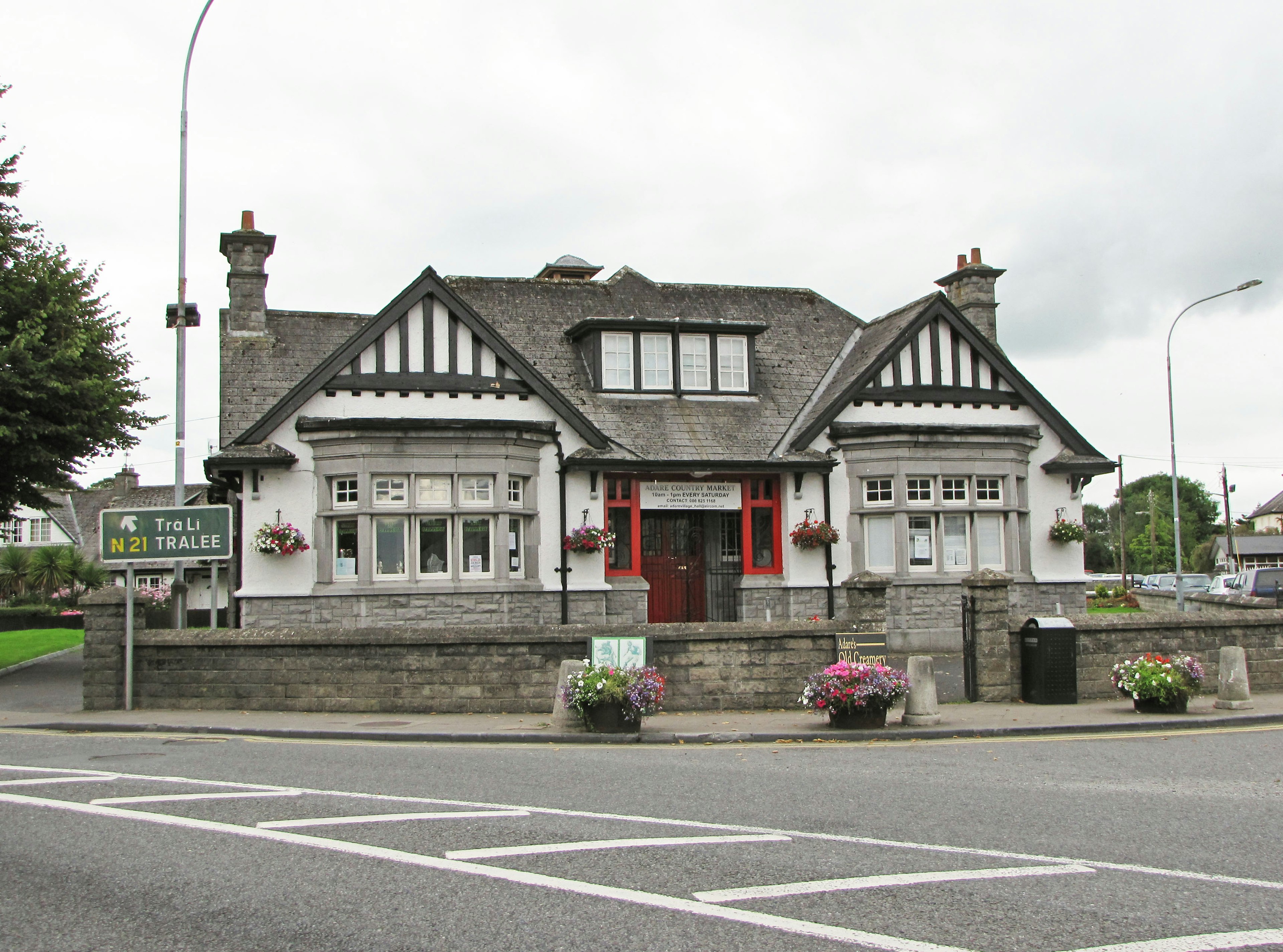 A distinctive building with a unique architectural style and surrounding greenery at an intersection