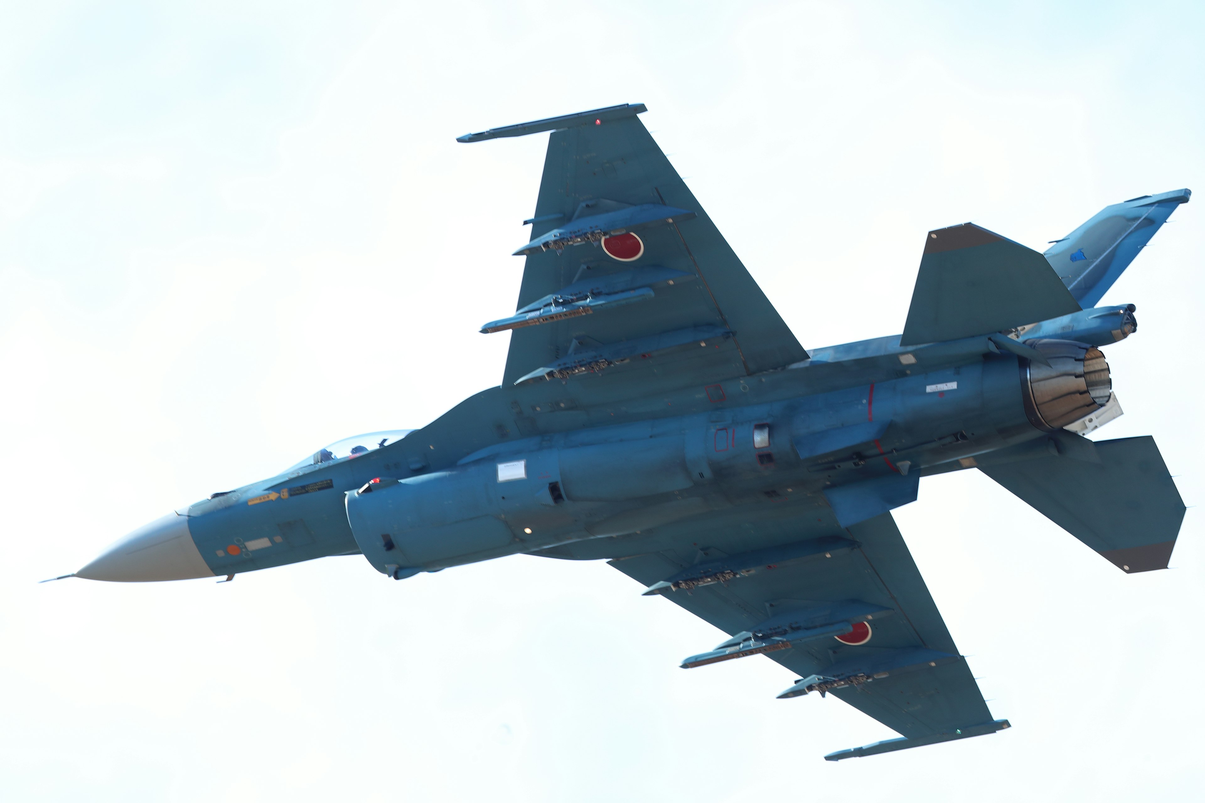 Side view of a Japanese fighter jet flying in the sky