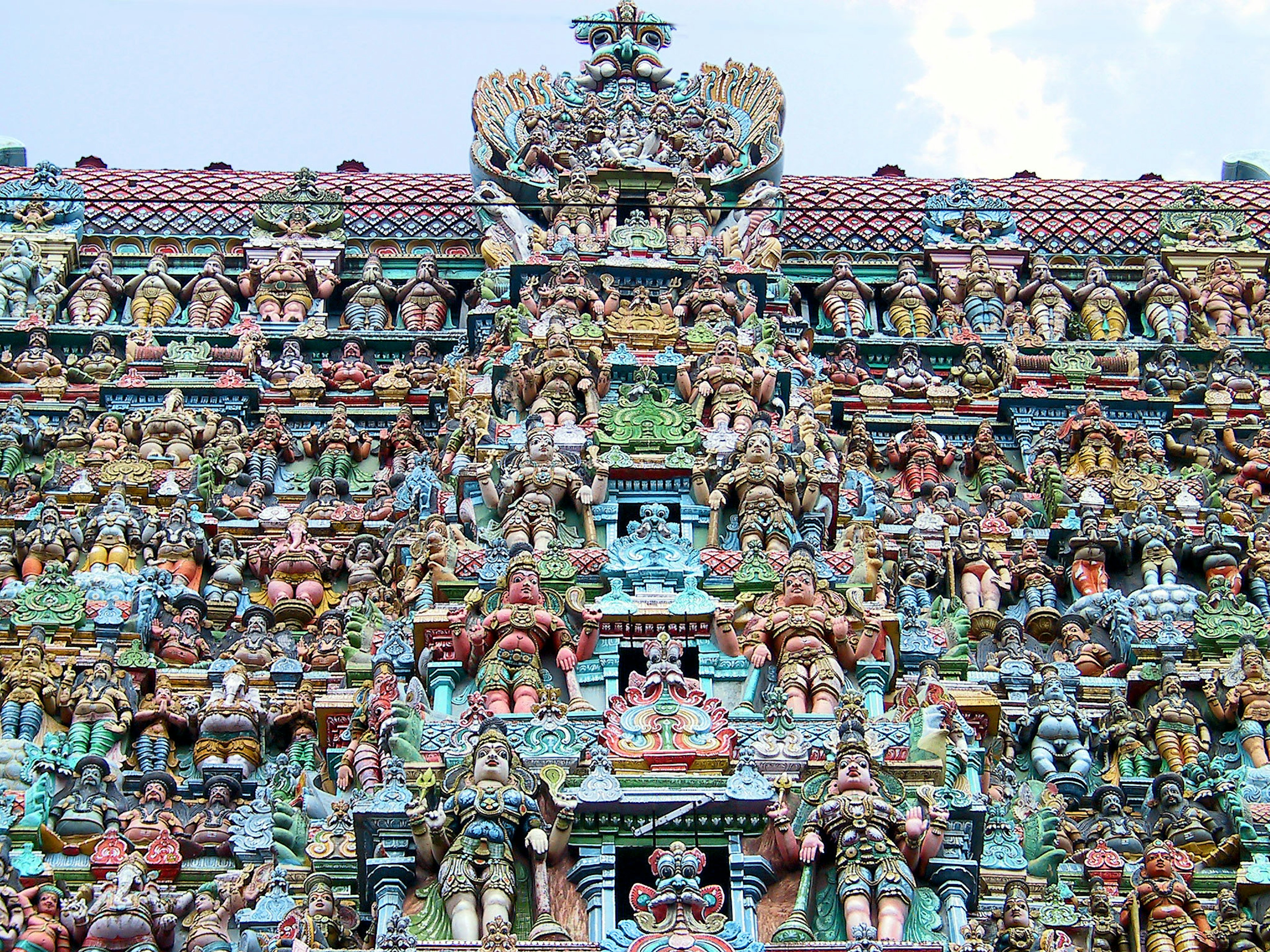 Vividly colored sculptures of deities and mythological figures on a temple wall