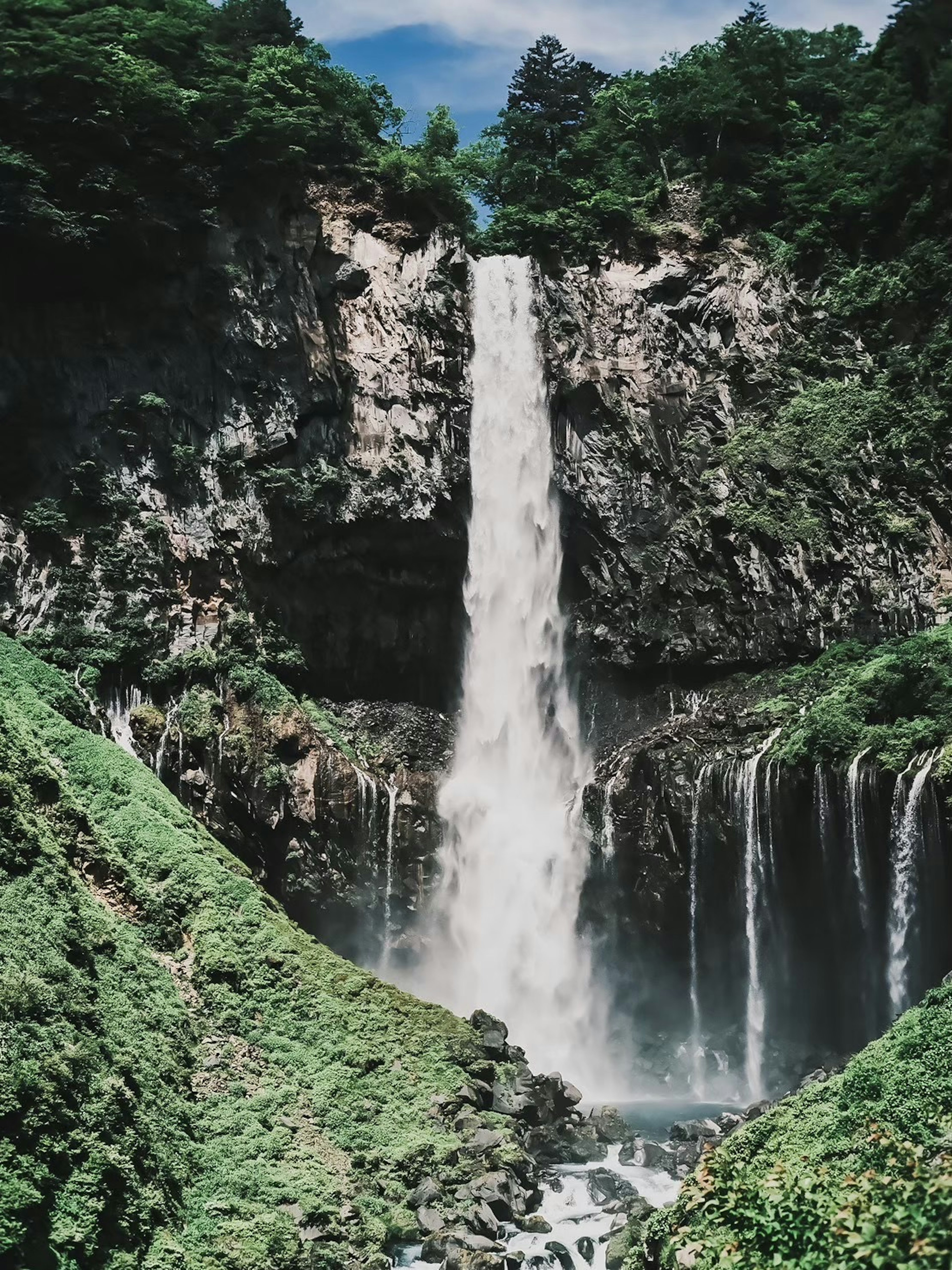 Majestic waterfall surrounded by lush greenery