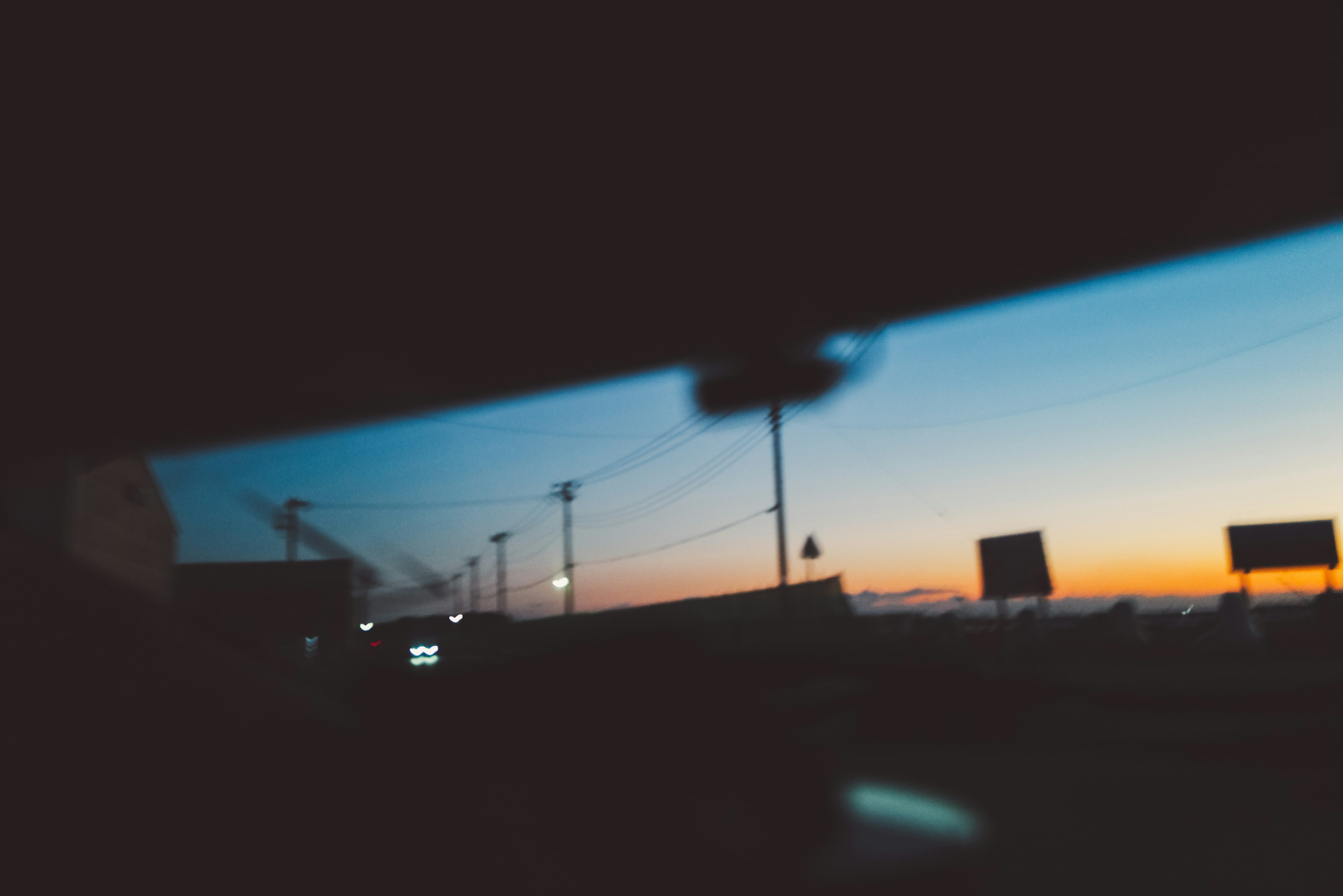 Scenic view of a sunset captured through a car window