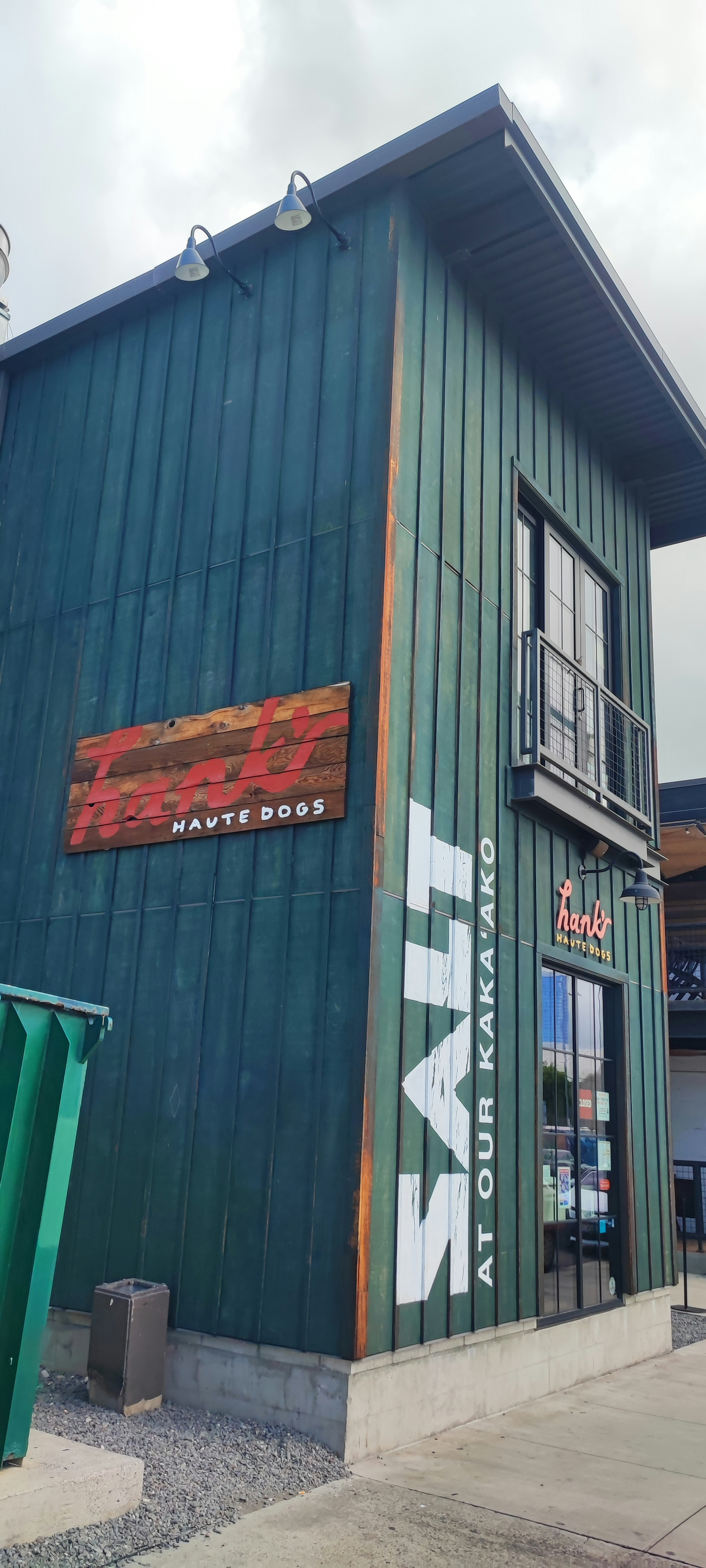 Green building exterior featuring large white text reading SALT