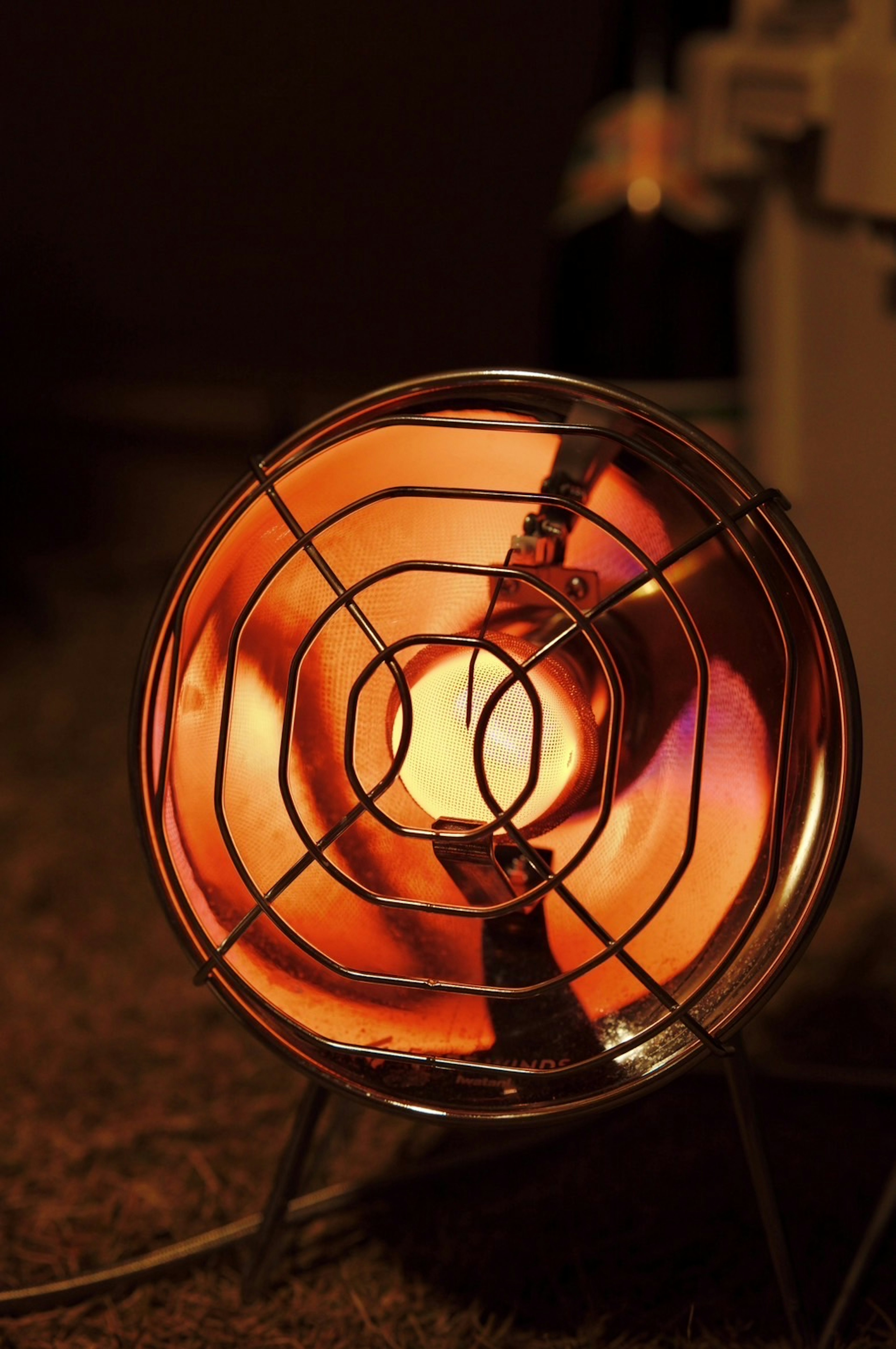 Metal fan heater emitting warm light