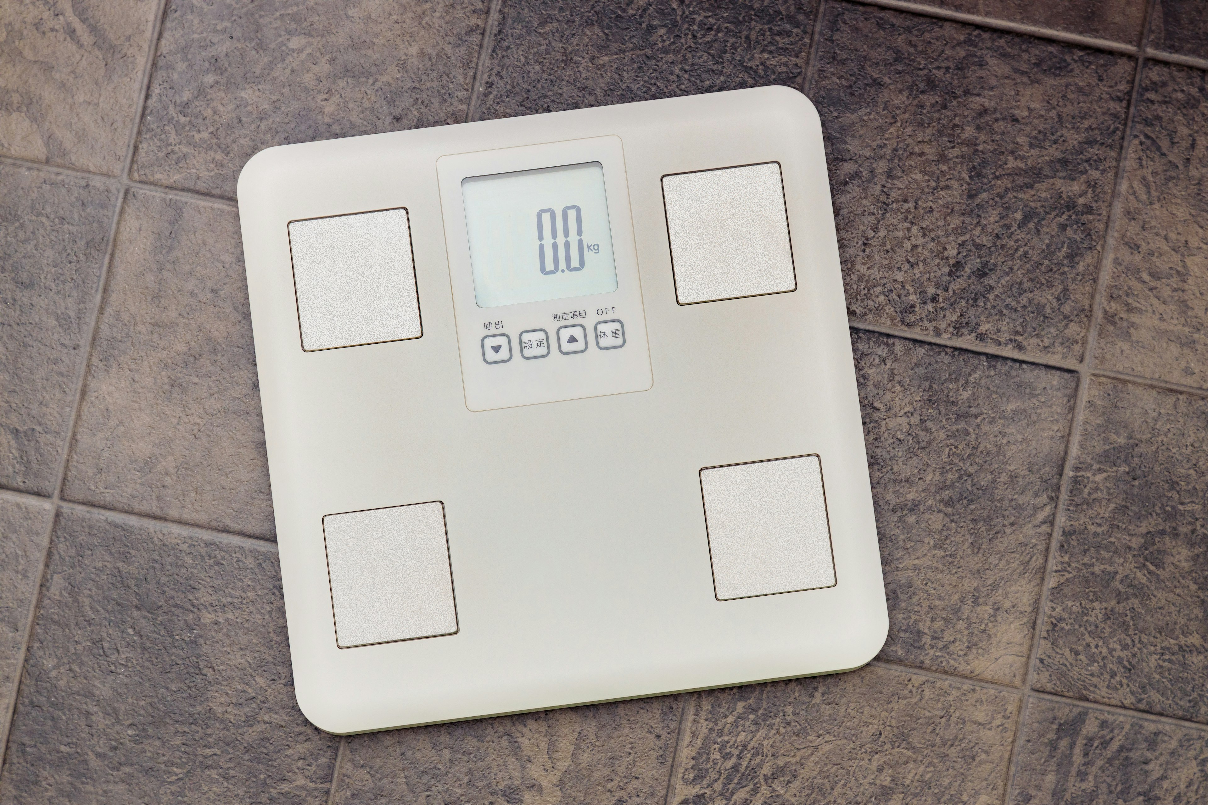 Digital weighing scale placed on the floor