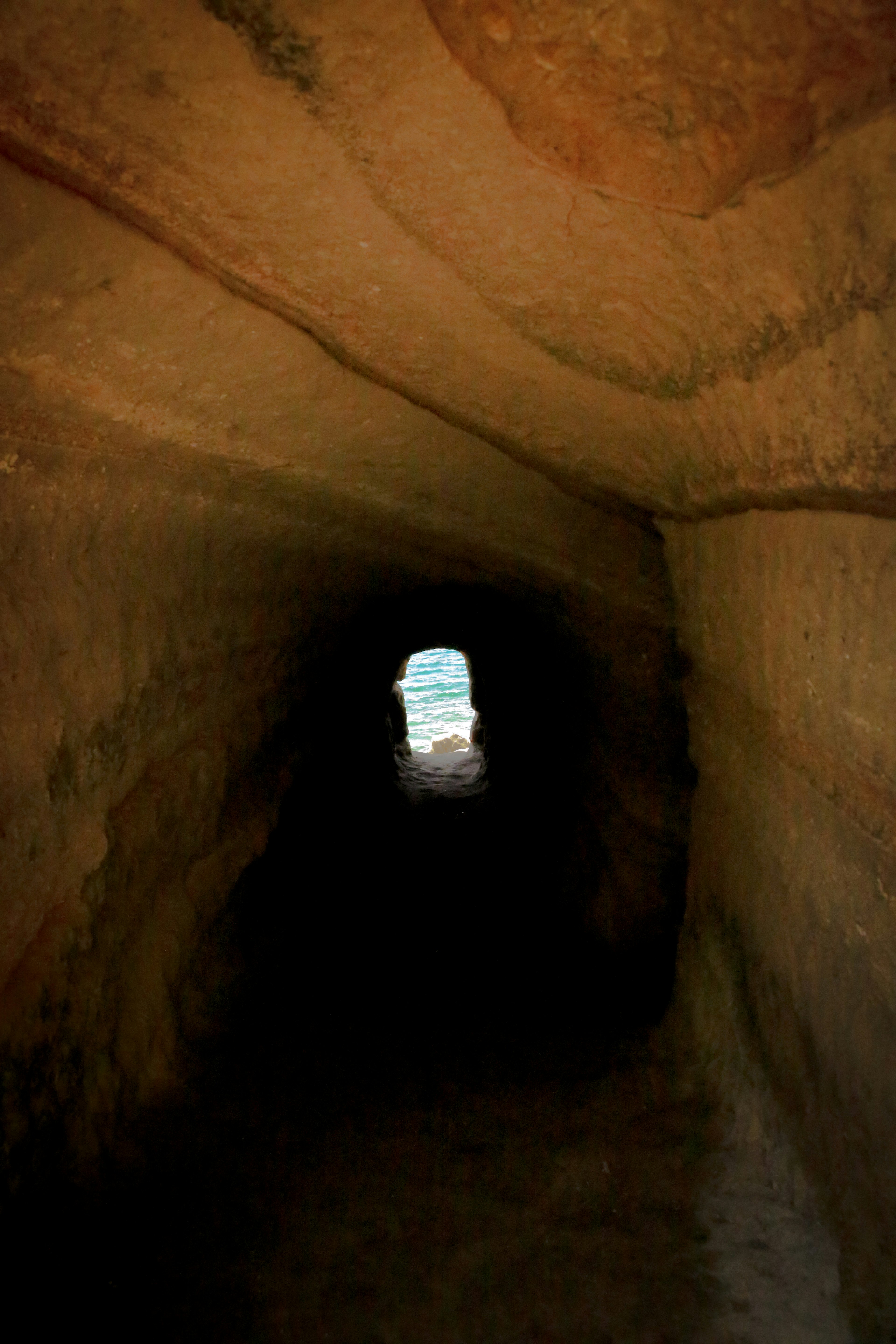 A dark tunnel leading to a visible light at the end