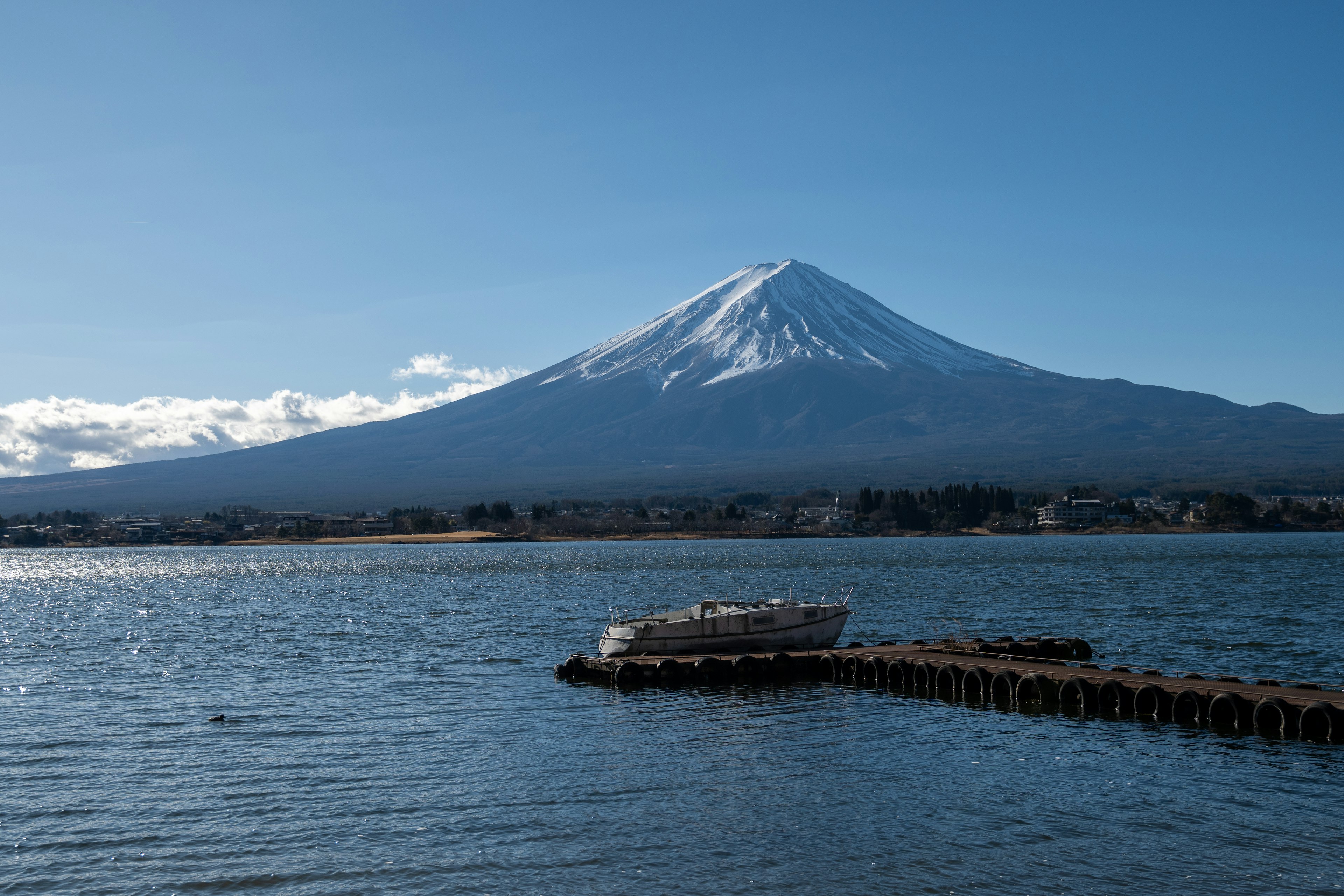 Snow-capped Mount Fuji with calm water surface