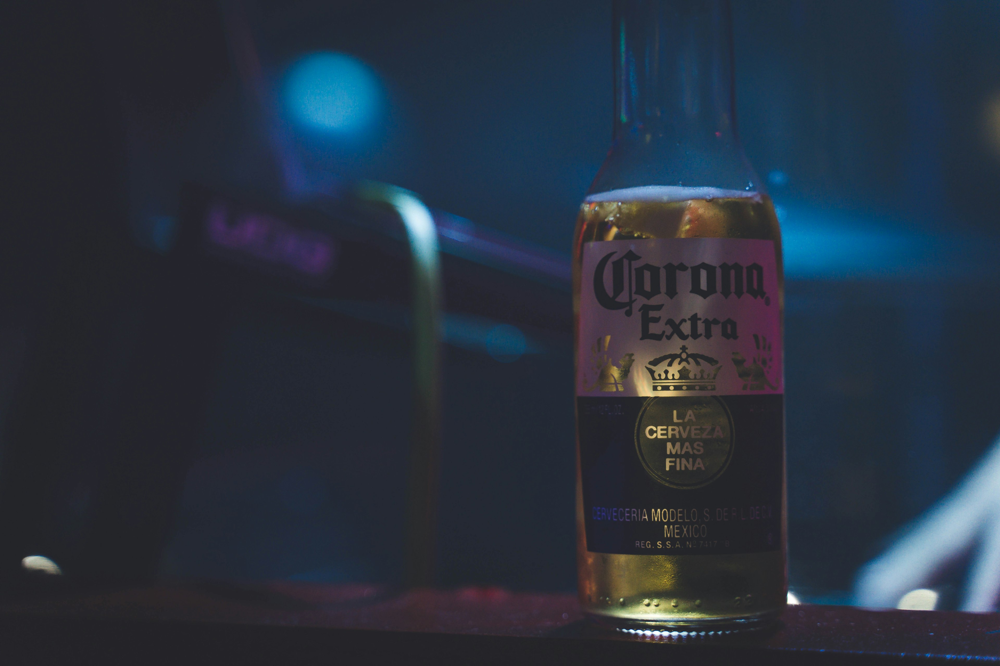 A Corona beer bottle placed against a dark background