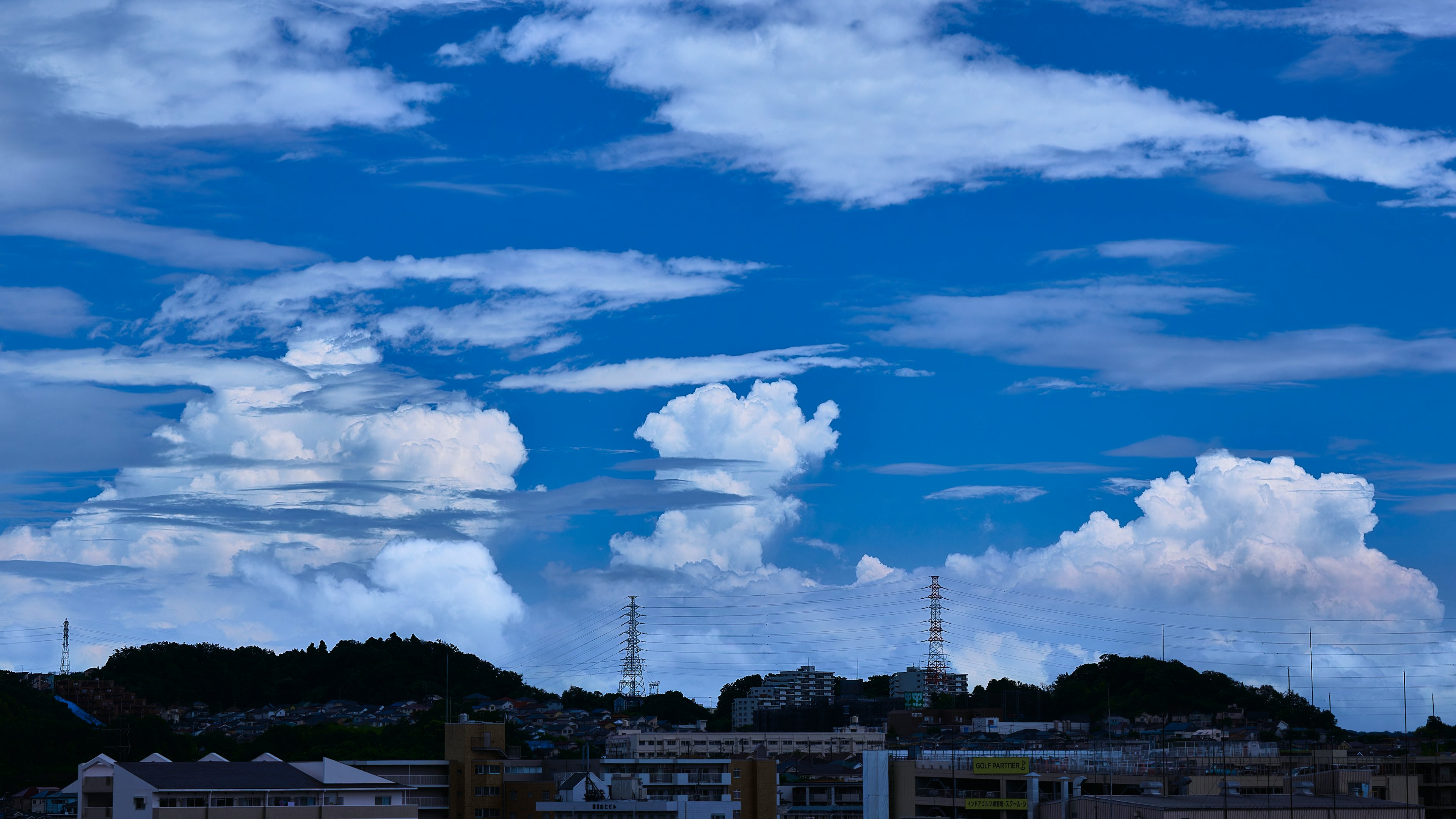 Vibrant blue sky with fluffy white clouds