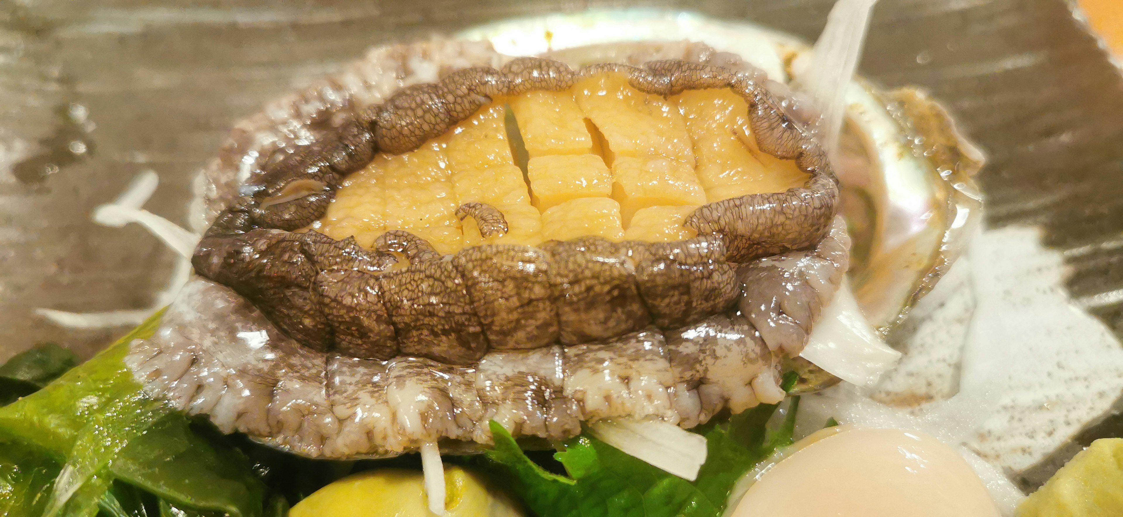 Fresh abalone served with green vegetables