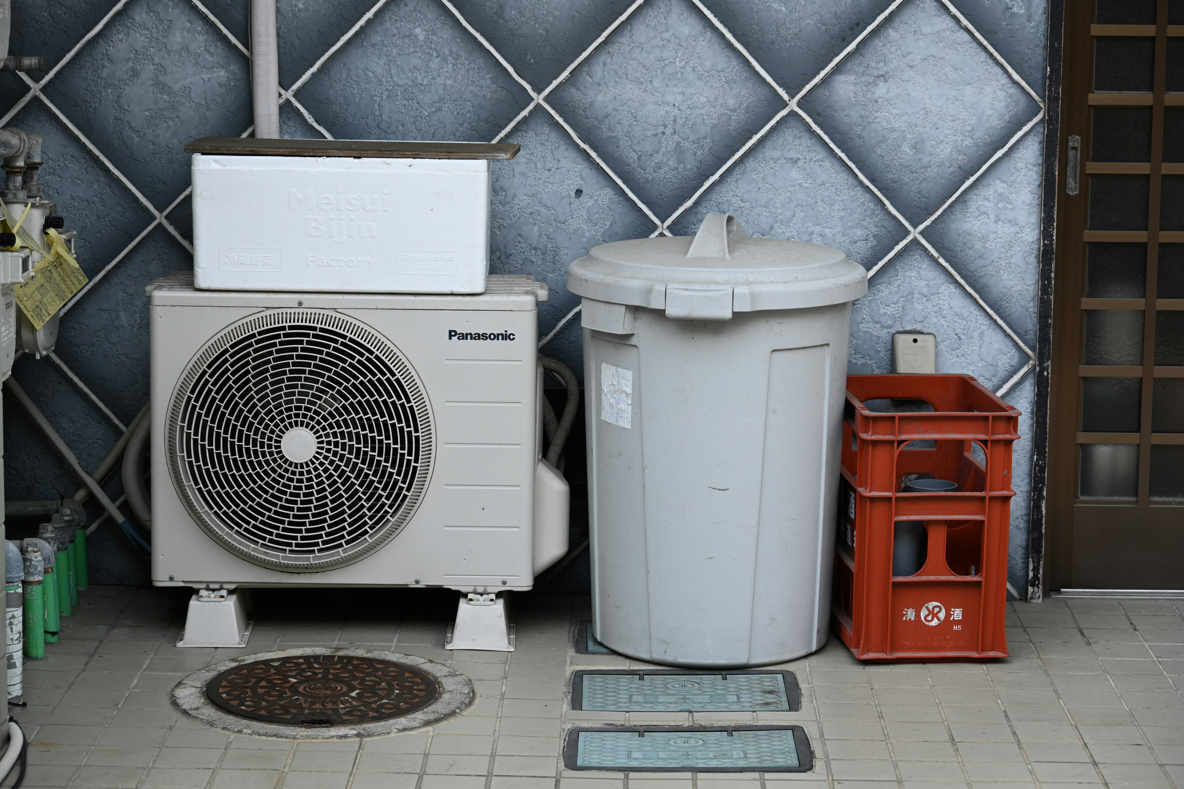 Scene with an outdoor air conditioning unit and a trash can