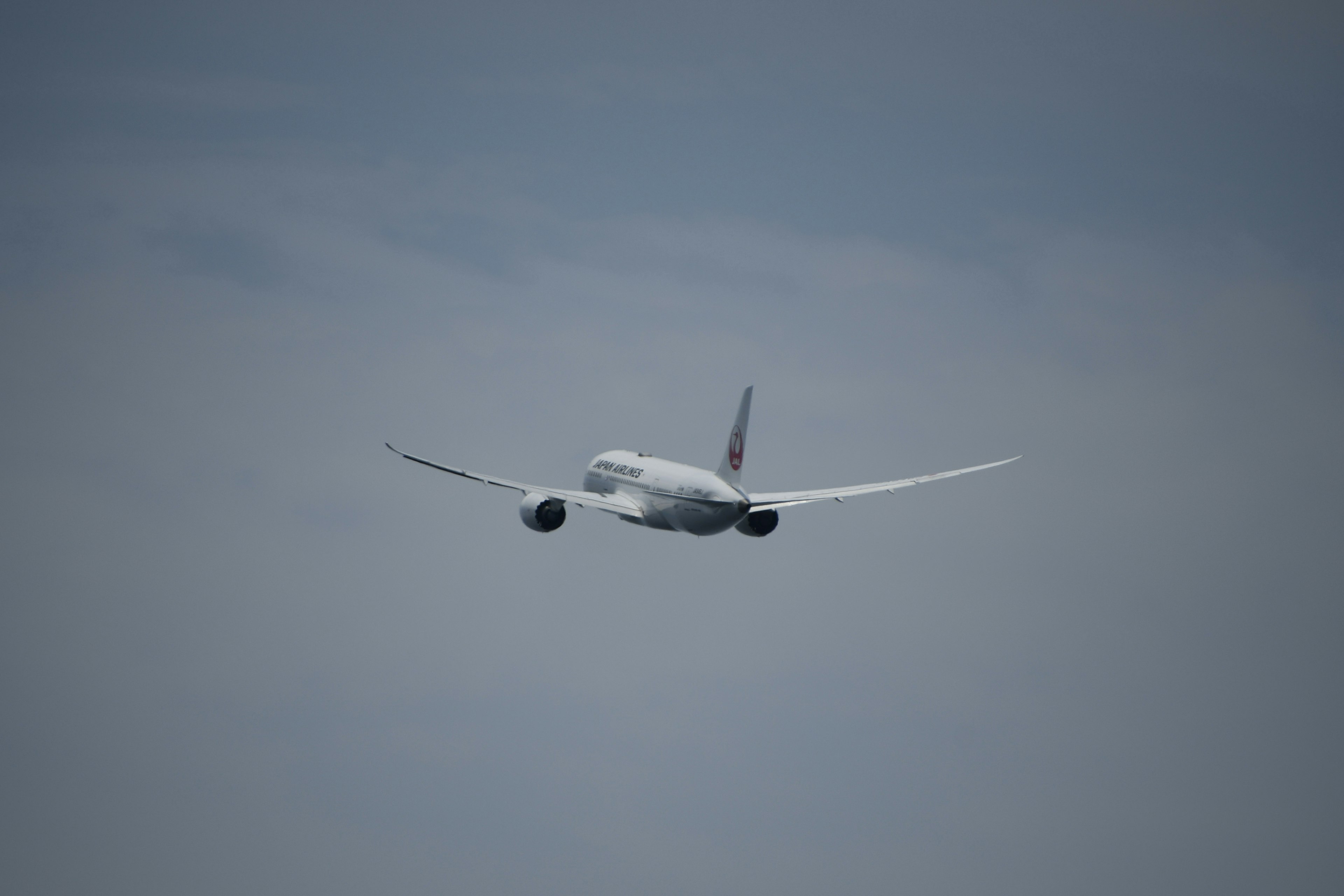 Airplane flying in the sky from behind