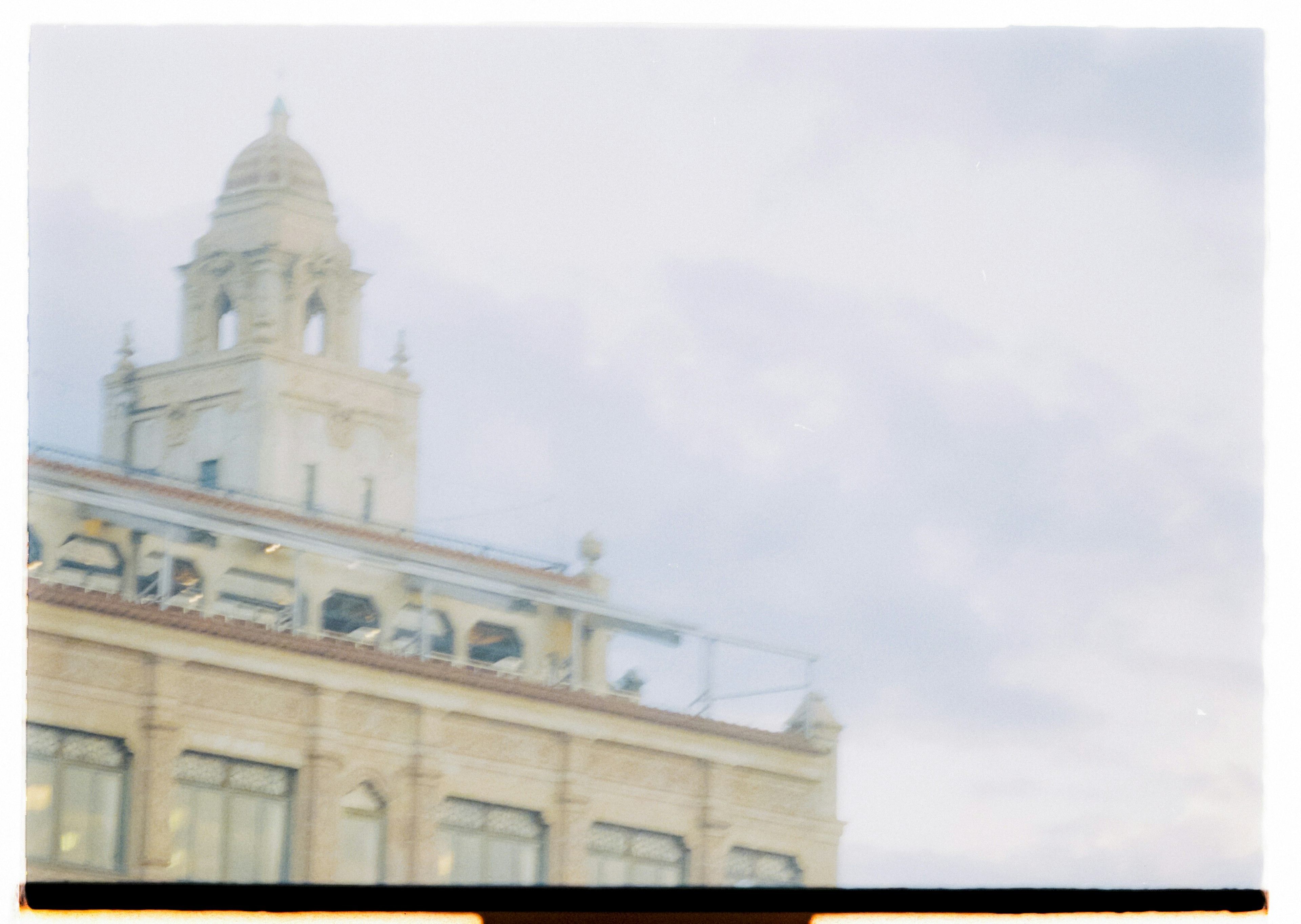 Historic building roof with dome under blue sky