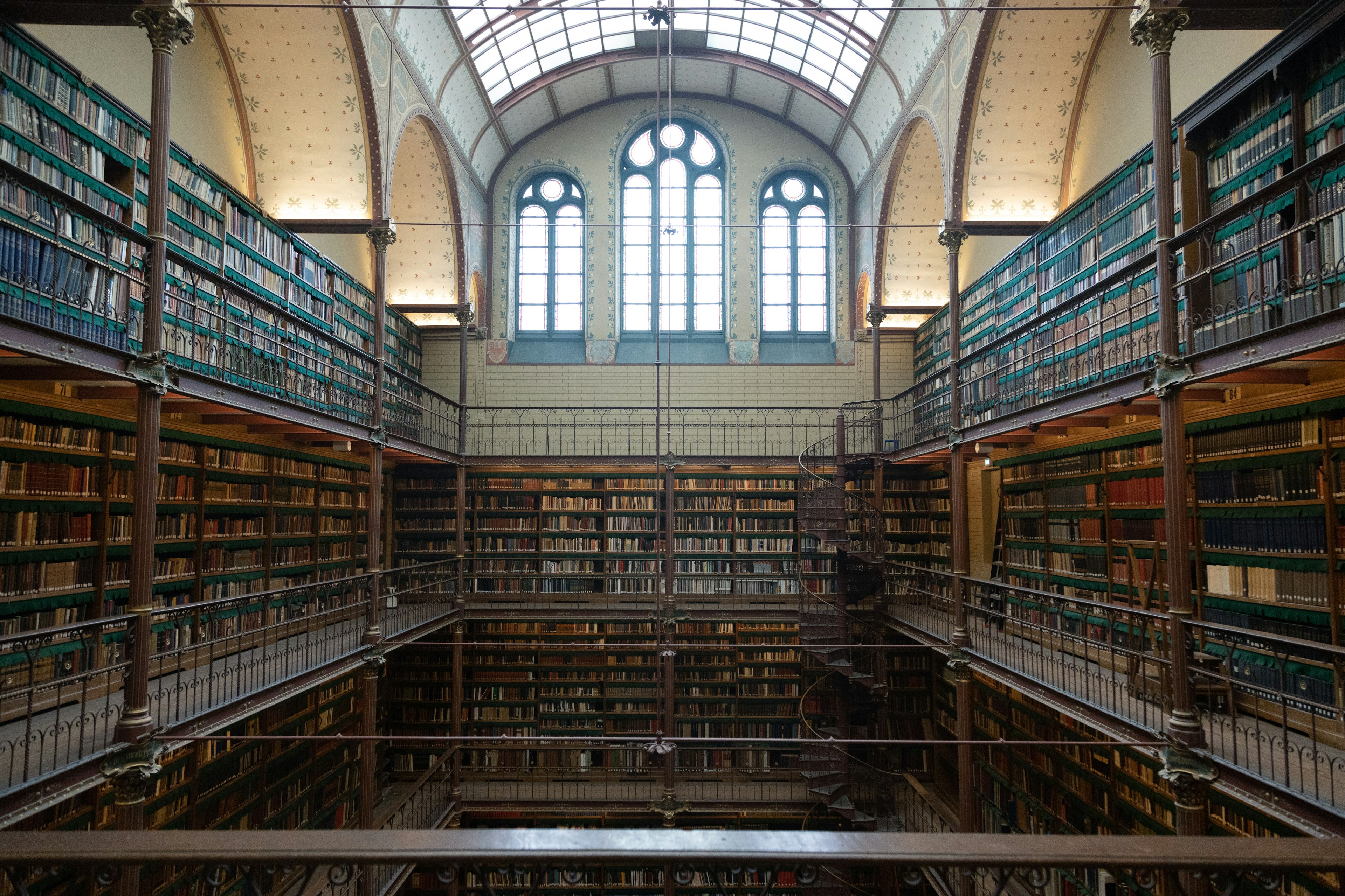 Interior of a beautiful library with tall windows and rows of bookshelves