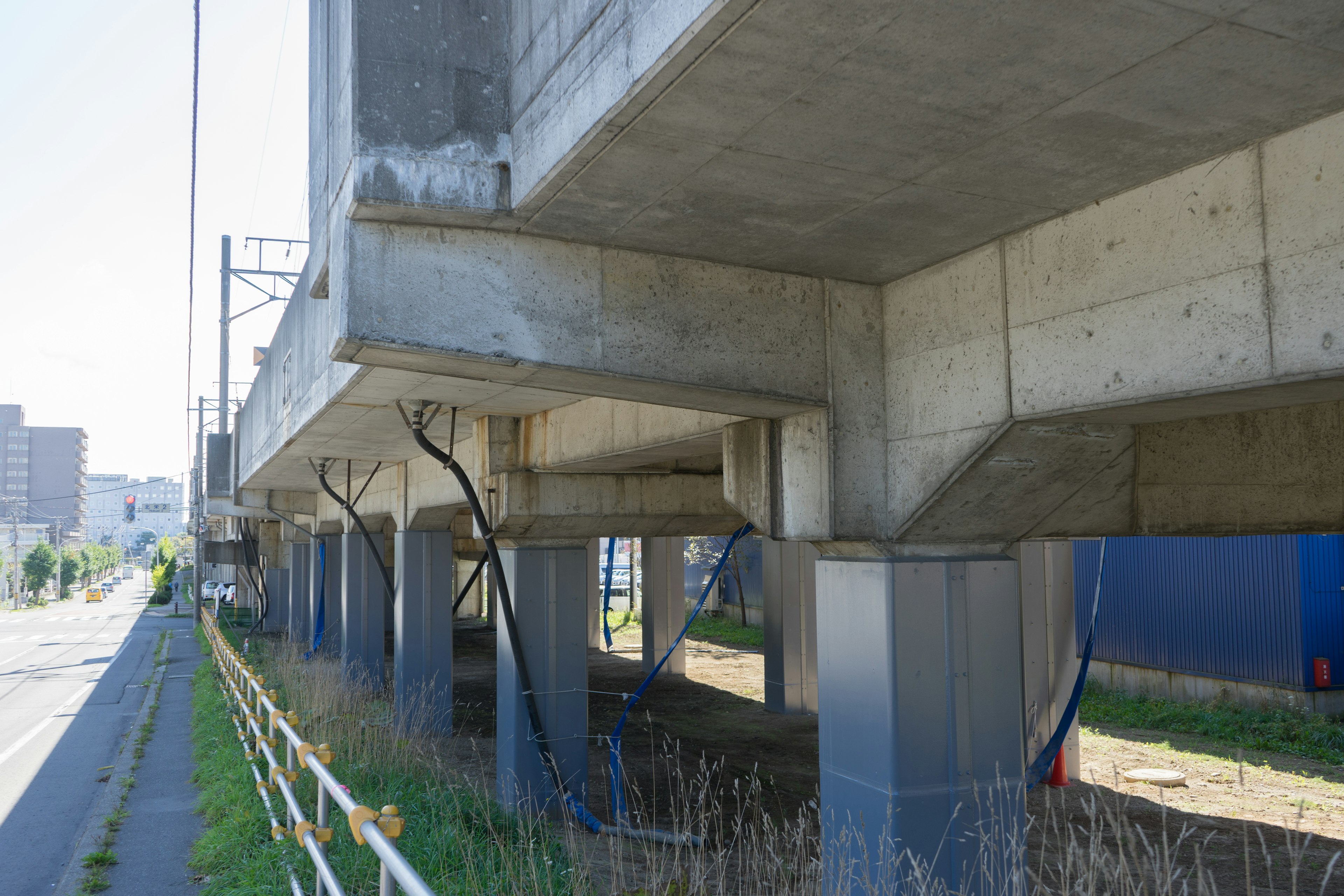 View of the underside structure and pillars of a concrete overpass