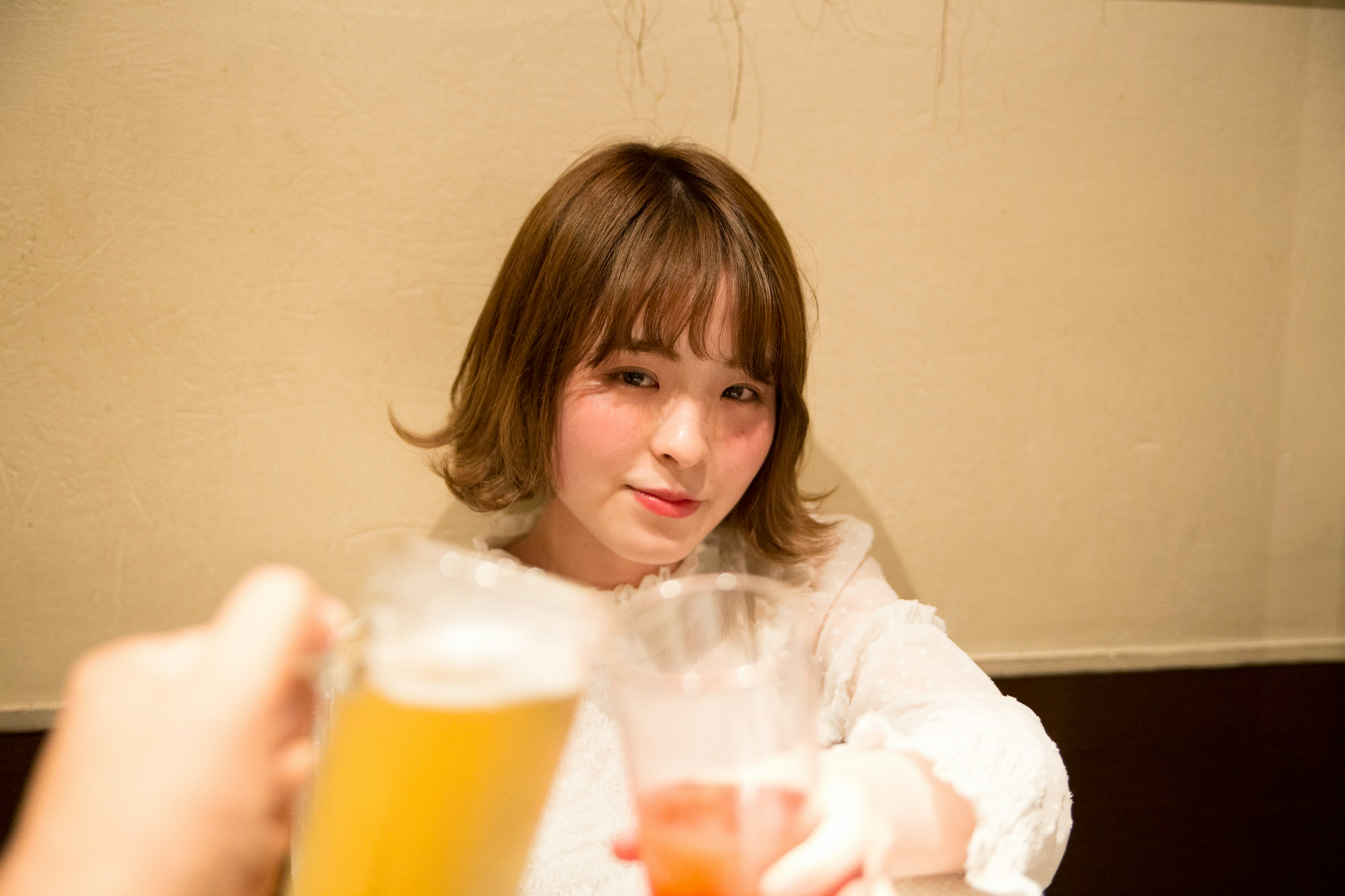 A woman holding a drink and toasting