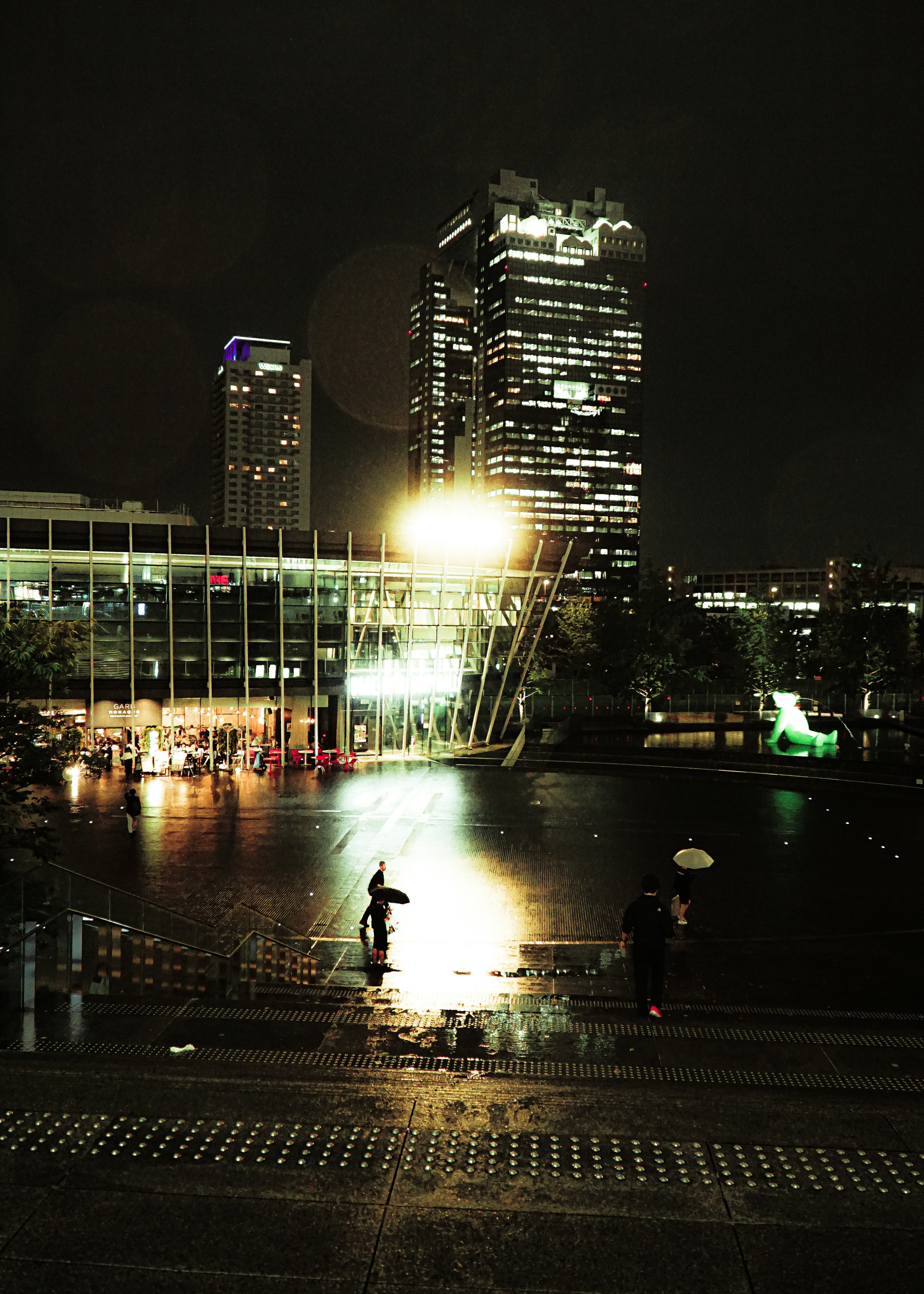 Nächtliche Stadtlandschaft mit Wolkenkratzern und Wasserreflexionen helle Lichter