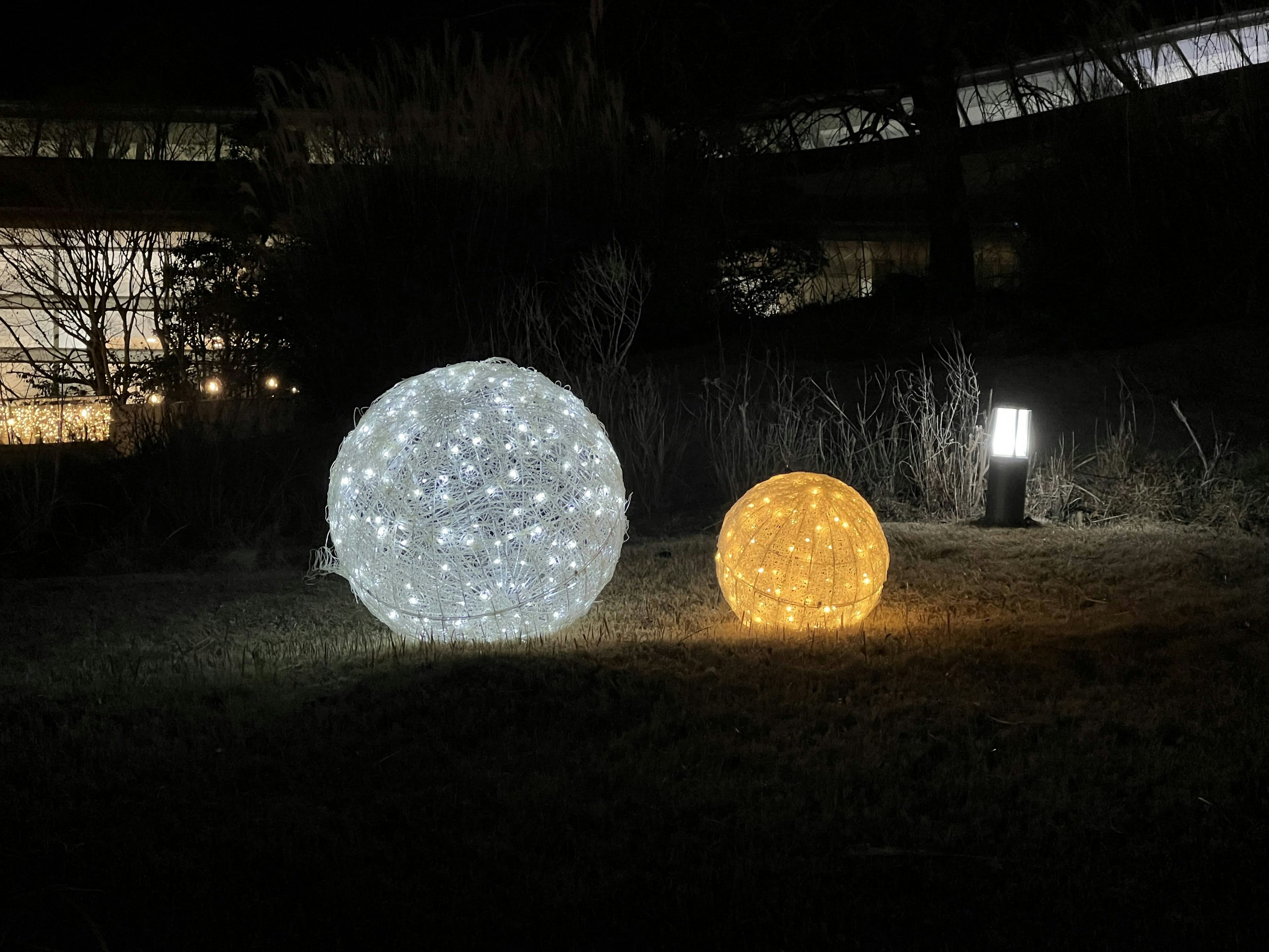 Decorative glowing spheres in white and orange set against a dark background