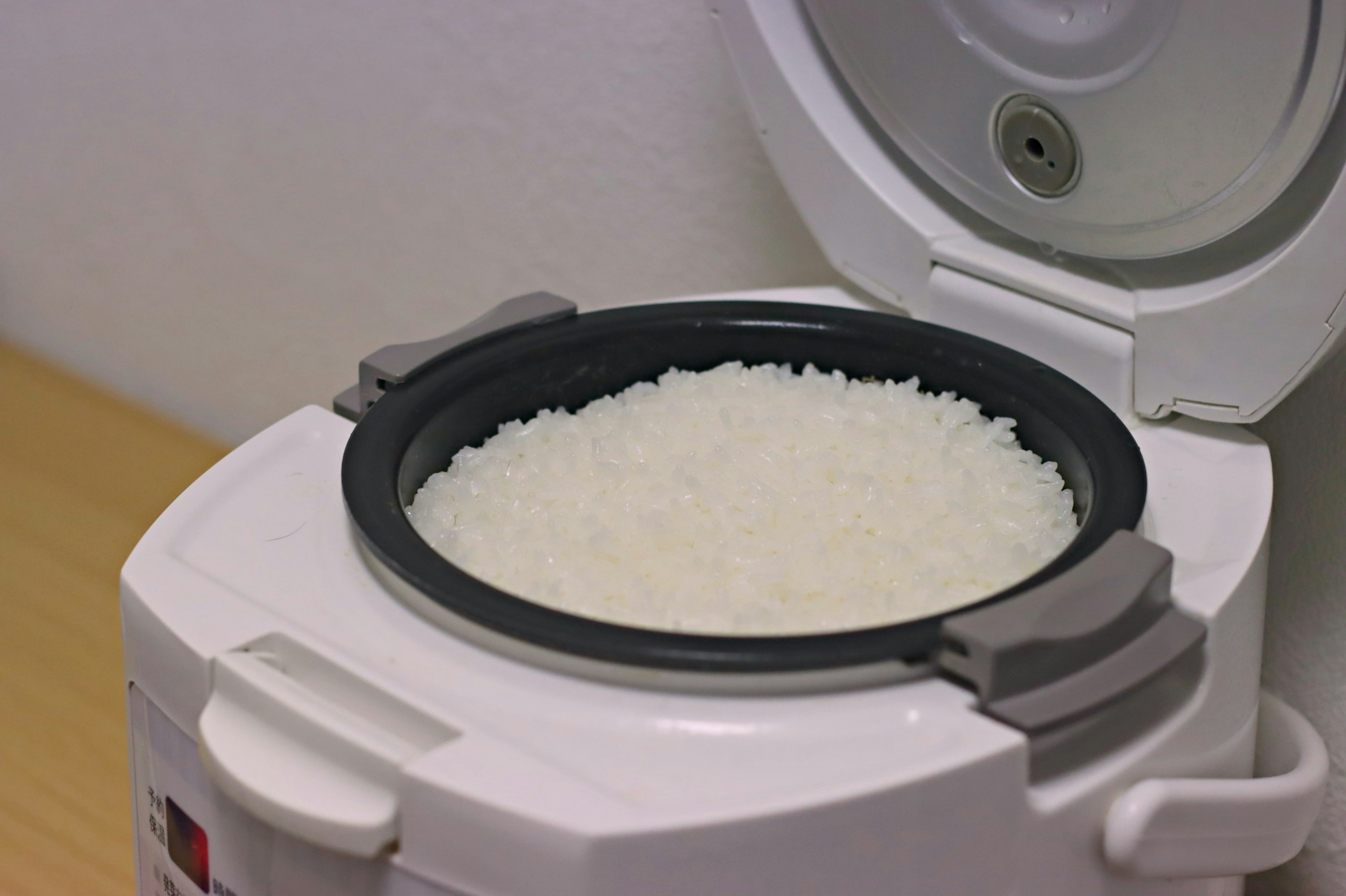 Inside of a rice cooker filled with white rice