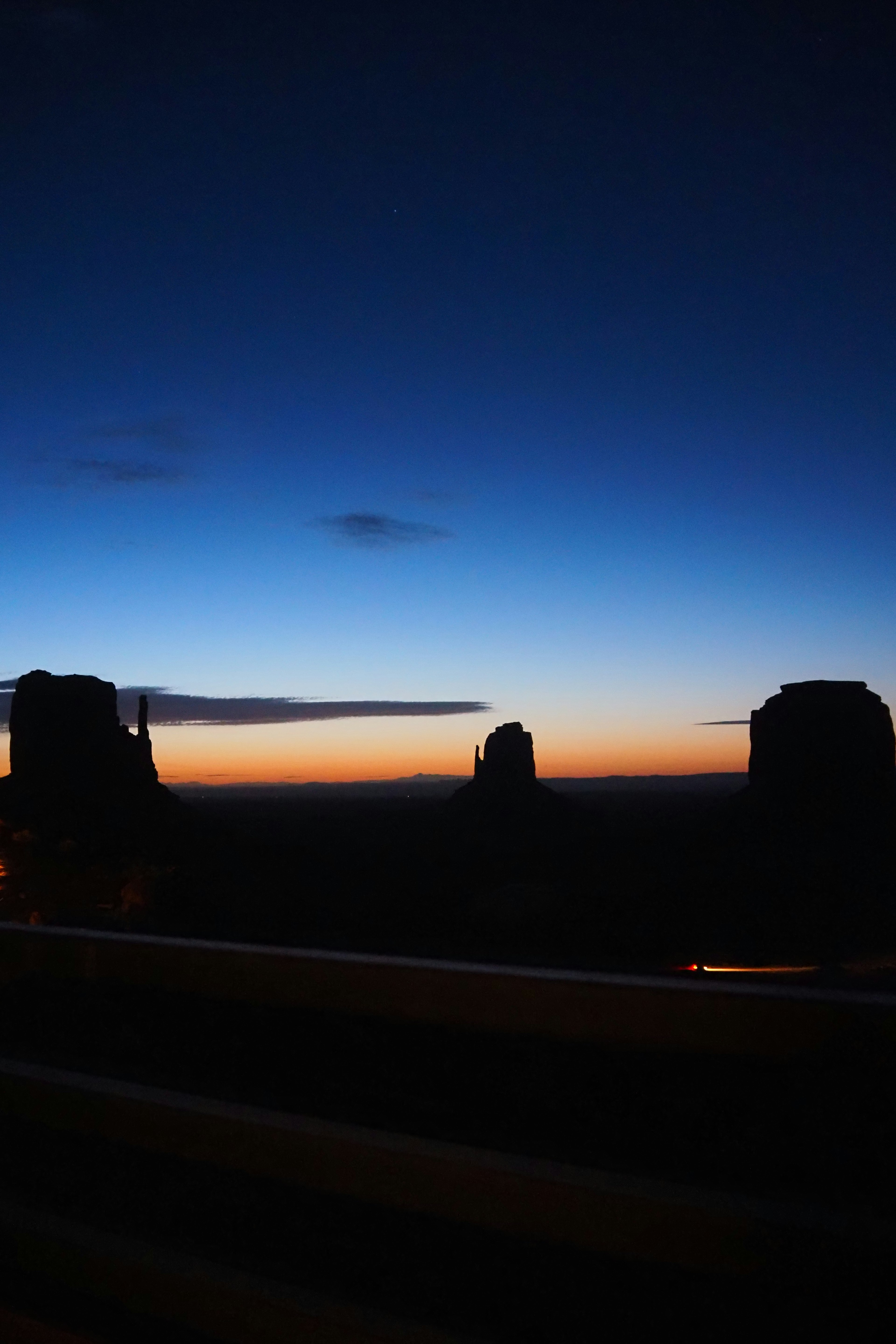 Silhouette of Monument Valley against a vibrant sunset sky