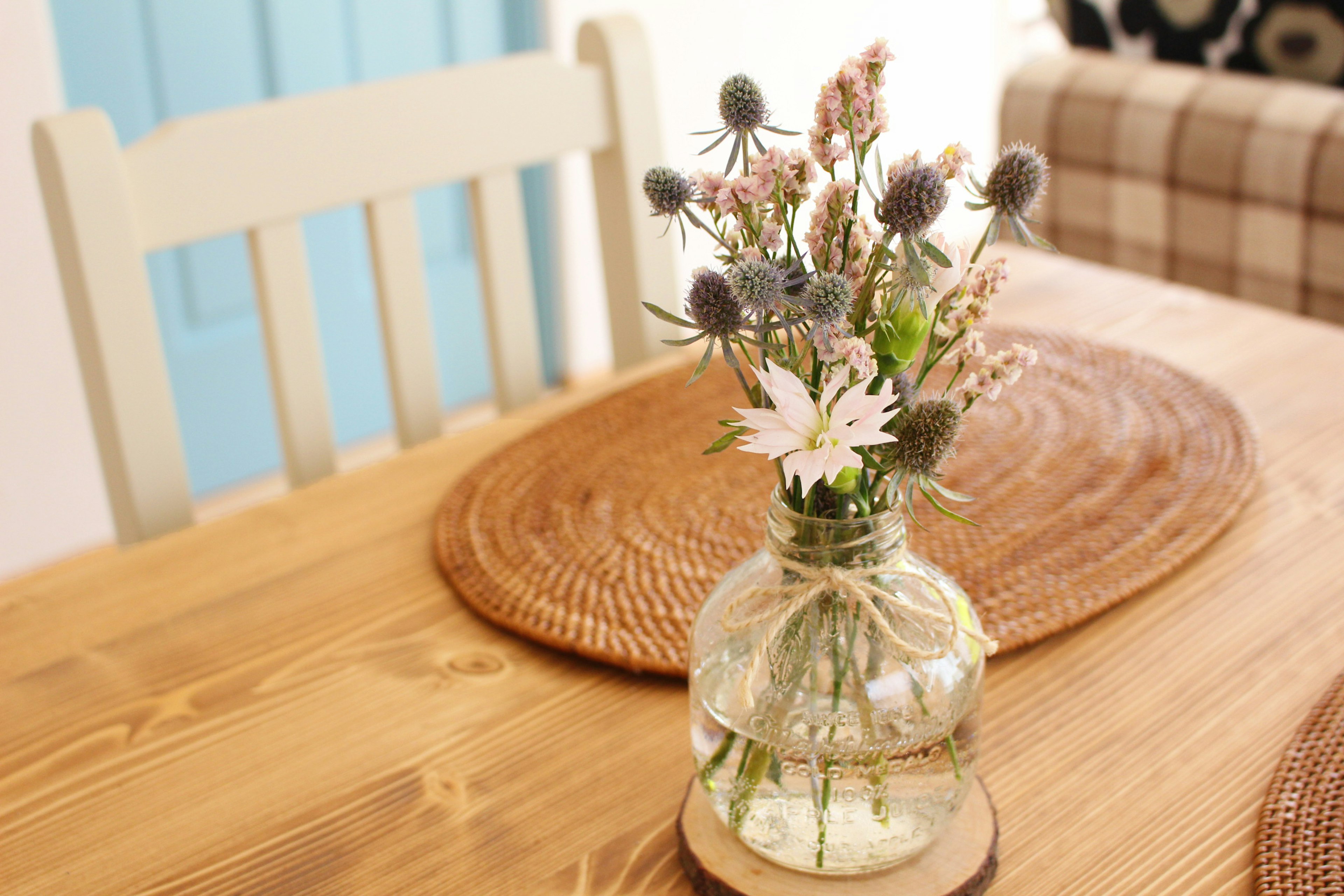 A vase of dried flowers on a wooden table